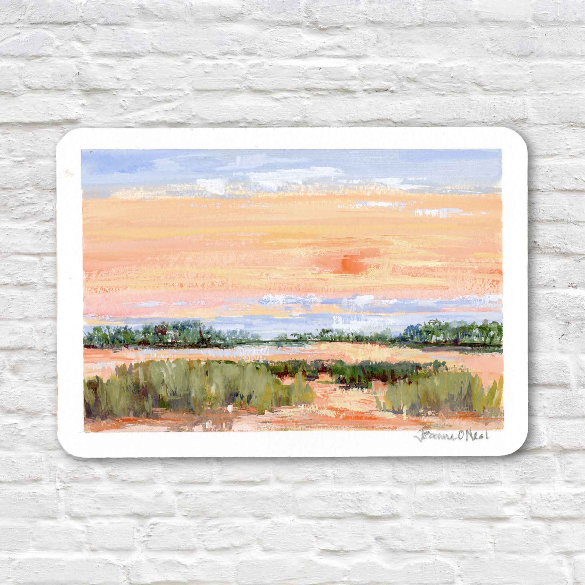 Low Sun by Jeanne O’Neal original gouache coastal sunset painting on postcard featuring a soft orange sky with a diffused low sun over calm water and green coastal grasses at Gray Man Gallery Pawleys Island