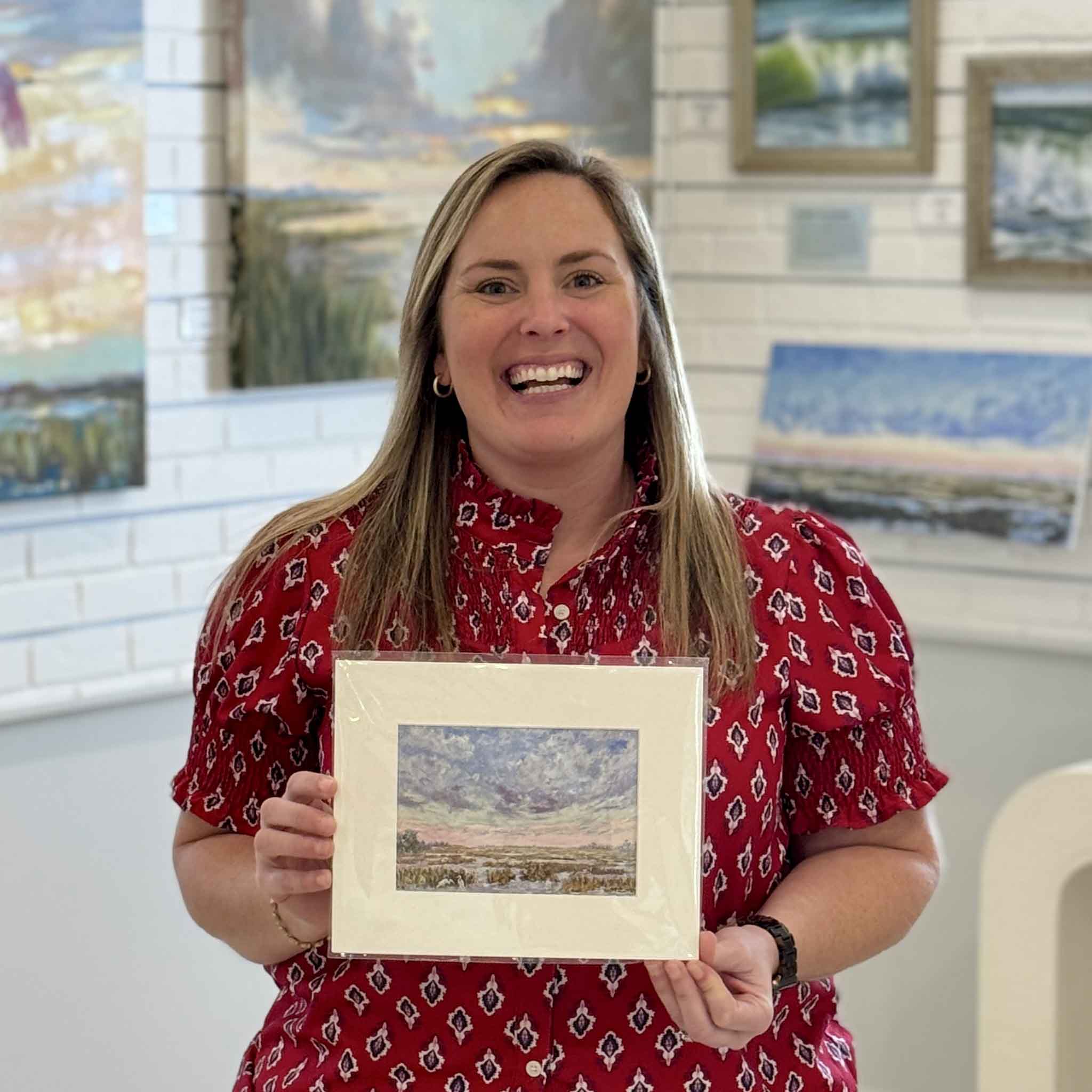 Bordy holding Pink Playground fine art giclée print by local artist Jeanne O’Neal professionally matted to standard 8x10 size at Gray Man Gallery Pawleys Island
