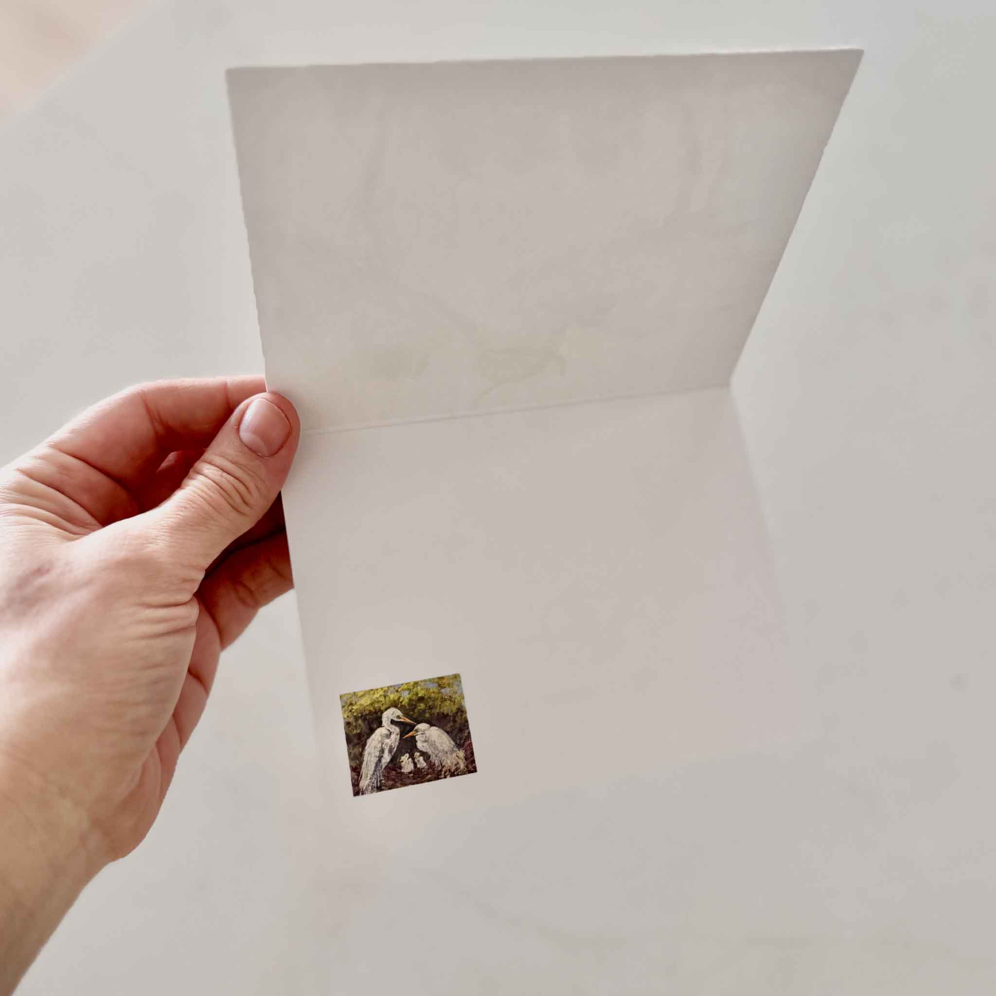 Blank interior of folded coastal art notecard from The Family blue heron painting by local Pawleys Island artist Jeanne O’Neal showing small printed artwork detail inside the card, part of a set of five blank notecards available at Gray Man Gallery