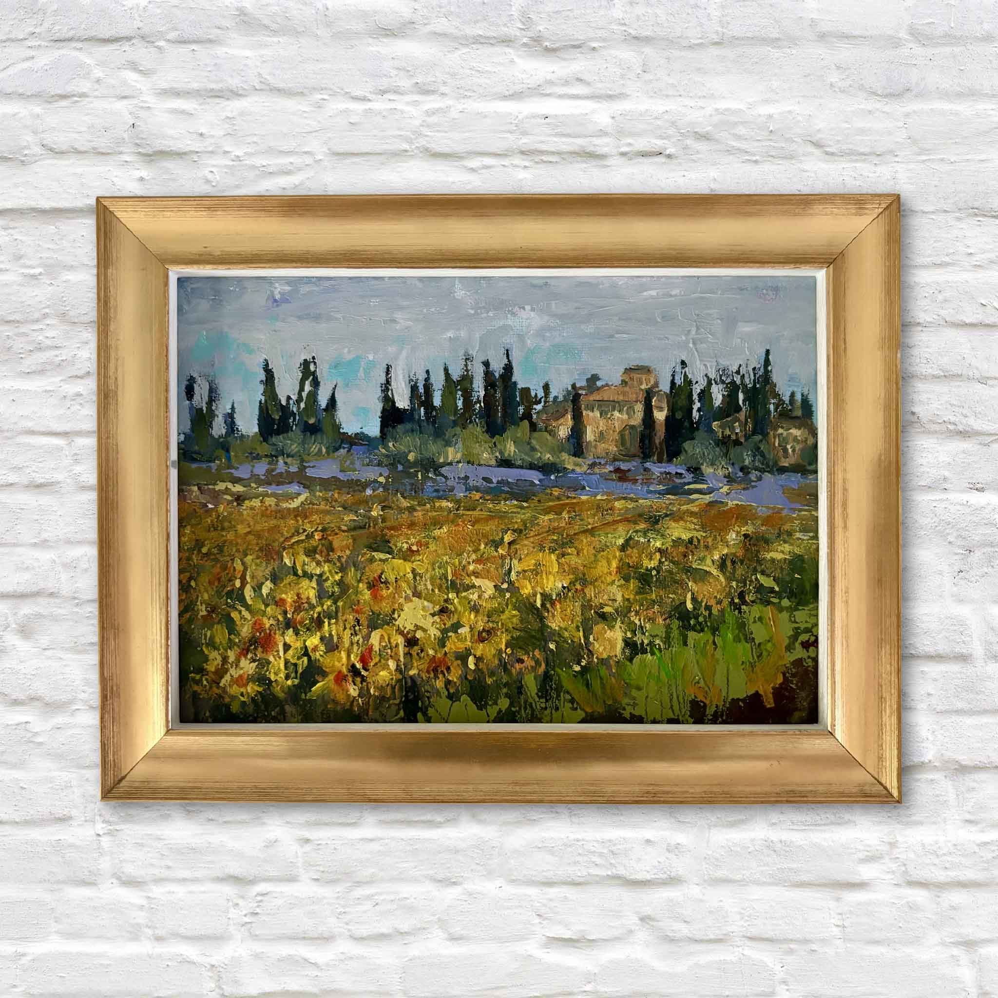 Tuscan Spring by Jeanne O'Neal, an original oil painting featuring a vibrant field of wildflowers, towering cypress trees, and a sunlit Tuscan villa, beautifully presented in the artist's signature gold frame at Gray Man Gallery.