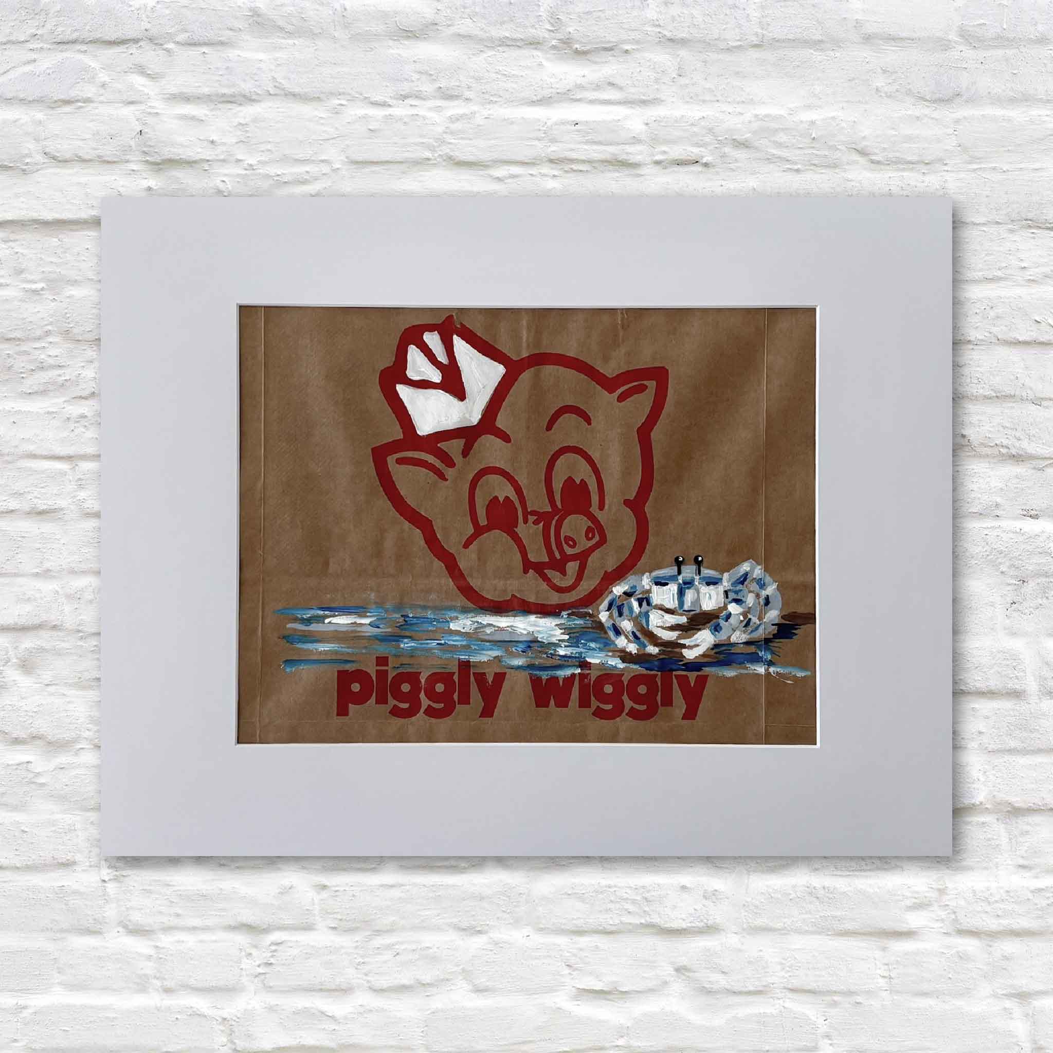 Original Piggly Wiggly Ghost Crab painting by local artist Jenny Reynolds at Gray Man Gallery, hand-painted on an authentic grocery bag featuring the iconic pig logo with a coastal ghost crab and marshy blue water, matted and displayed in the gallery
