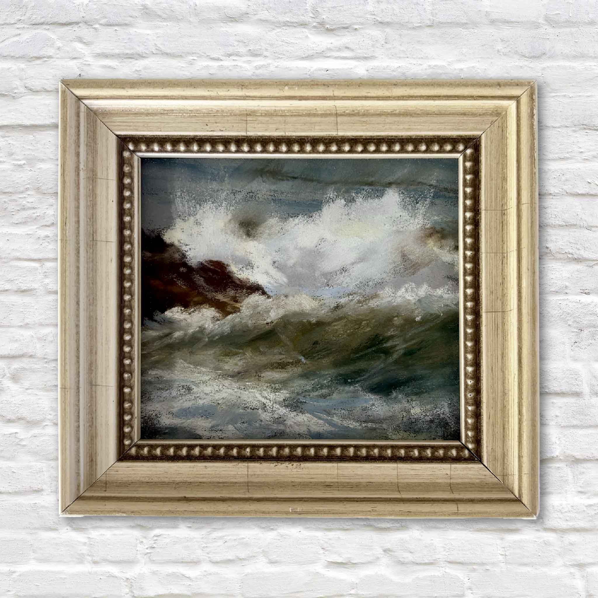 Original framed pastel painting Splash by local artist Joanne Willoughby featuring a crashing Atlantic wave against rocky shoreline, professionally framed with Water White glass and available at Gray Man Gallery in Pawleys Island, South Carolina.