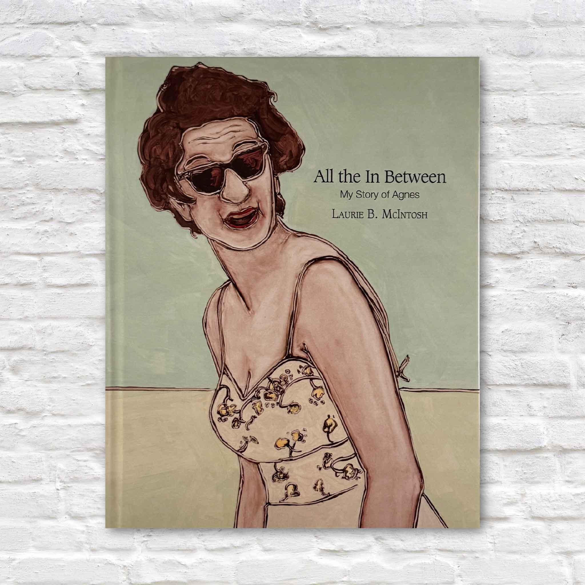 Signed hardcover copy of All the In Between: My Story of Agnes by Laurie Brownell McIntosh, an illustrated memoir featuring more than seventy original paintings, available at Gray Man Gallery in Pawleys Island, South Carolina.