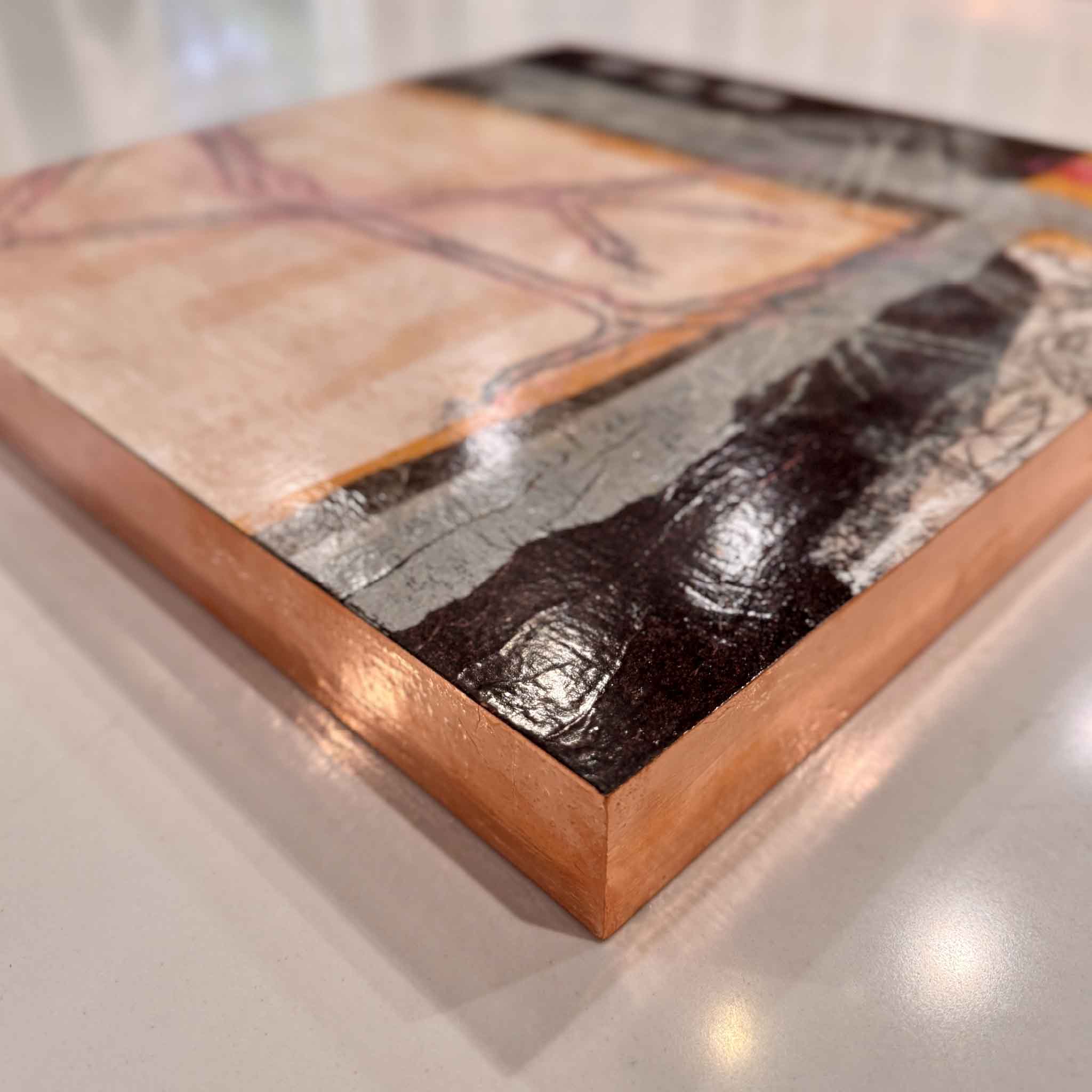 Close-up of Henredon D showing glossy surface and rose-gold leafed edges