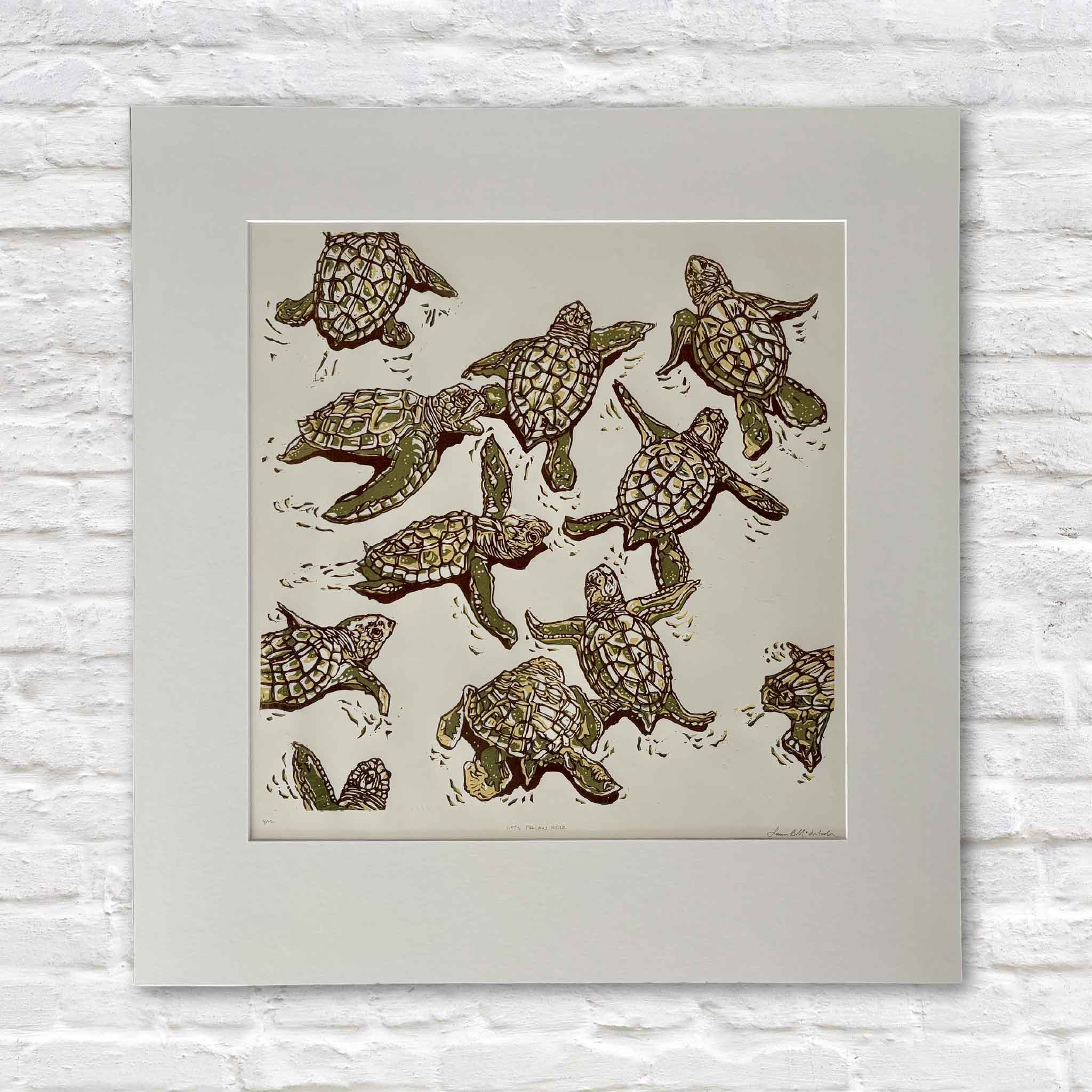 Let’s Follow Her by Laurie McIntosh, an original signed and numbered hand-pulled reduction linocut depicting a group of sea turtles swimming together in layered olive green, ochre and brown, professionally matted and available at Gray Man Gallery in Pawleys Island, South Carolina.