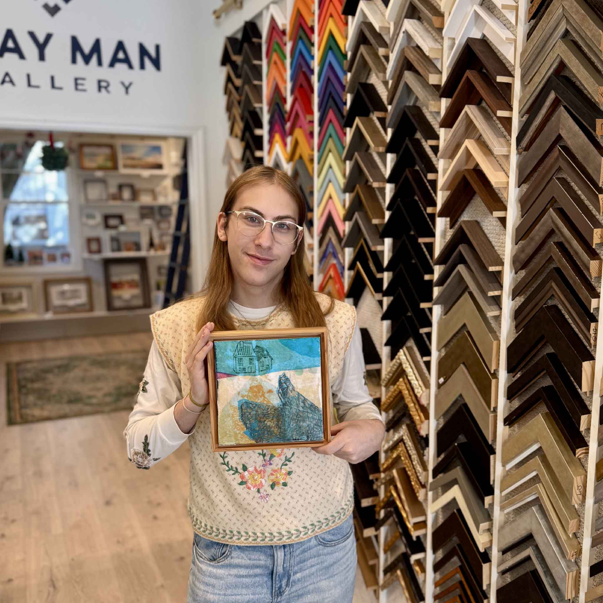 A Gray Man Gallery team member holding Laurie McIntosh’s “1C” mixed-media artwork to show size and scale.