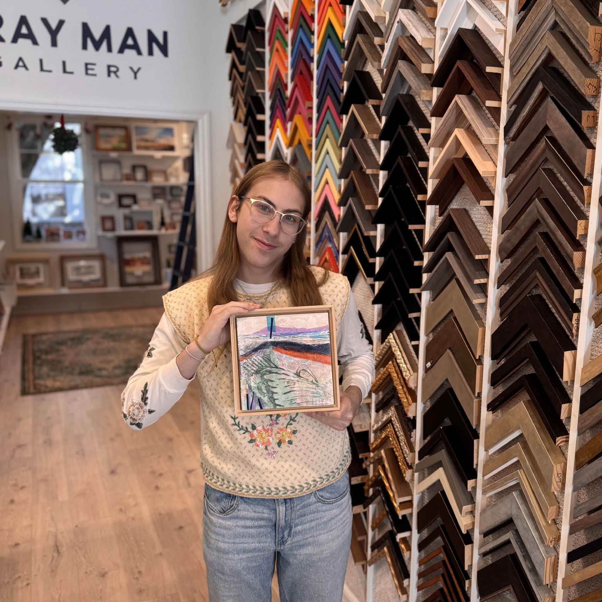 Gallery team member holding Residuals 2A to show the artwork’s scale and framed dimensions.