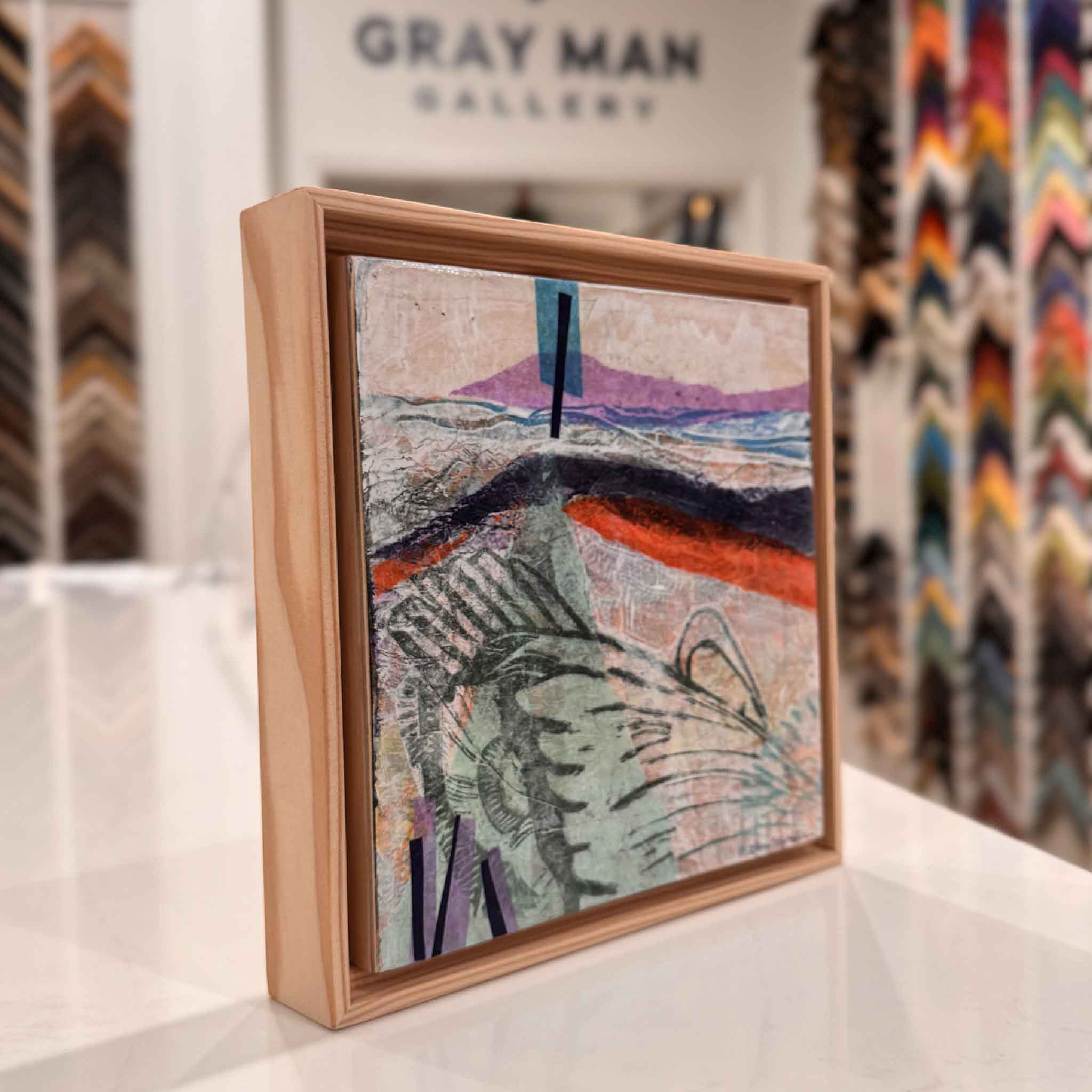 Side detail of Residuals 2A showing layered texture and the natural wooden floater frame inside Gray Man Gallery.