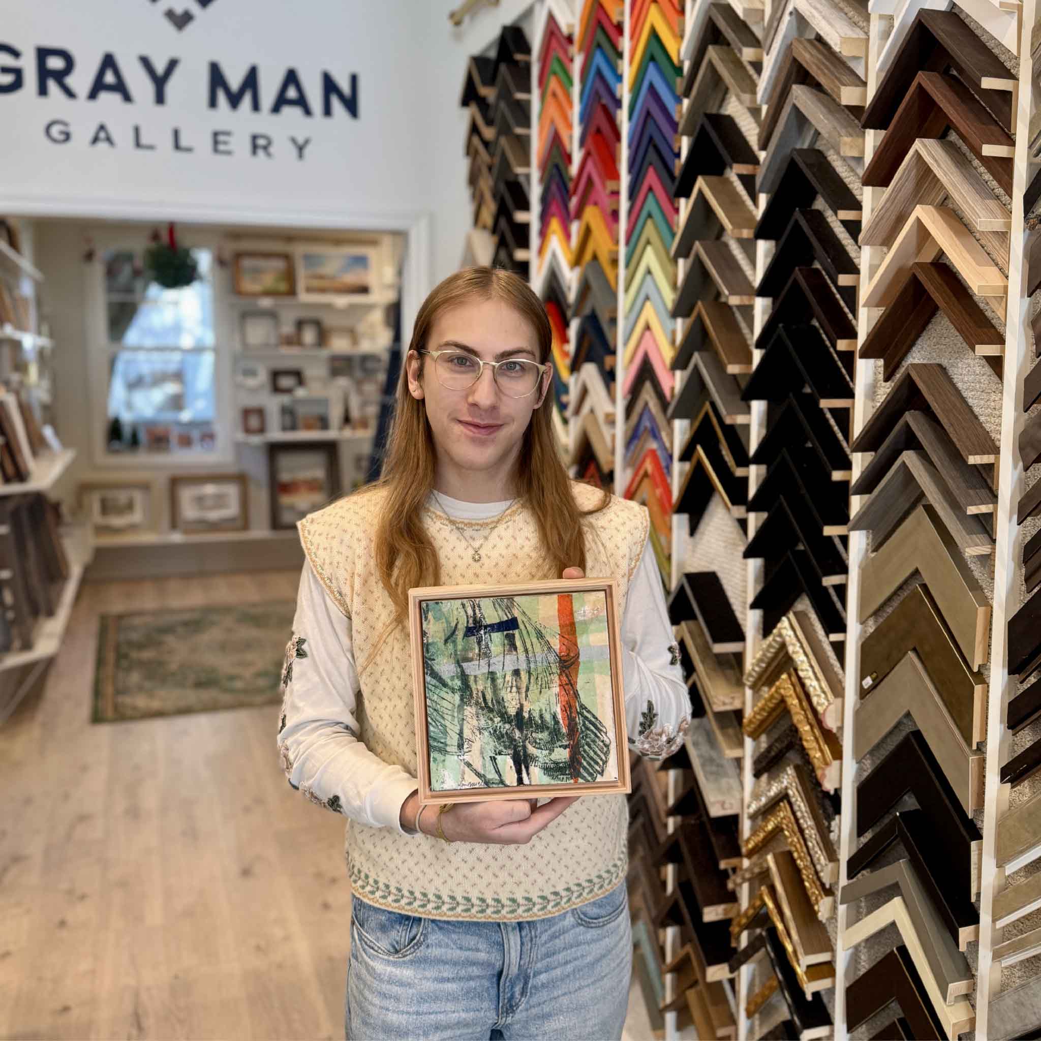 A Gray Man Gallery team member holding Laurie McIntosh’s “3B” mixed-media artwork to show size and scale.