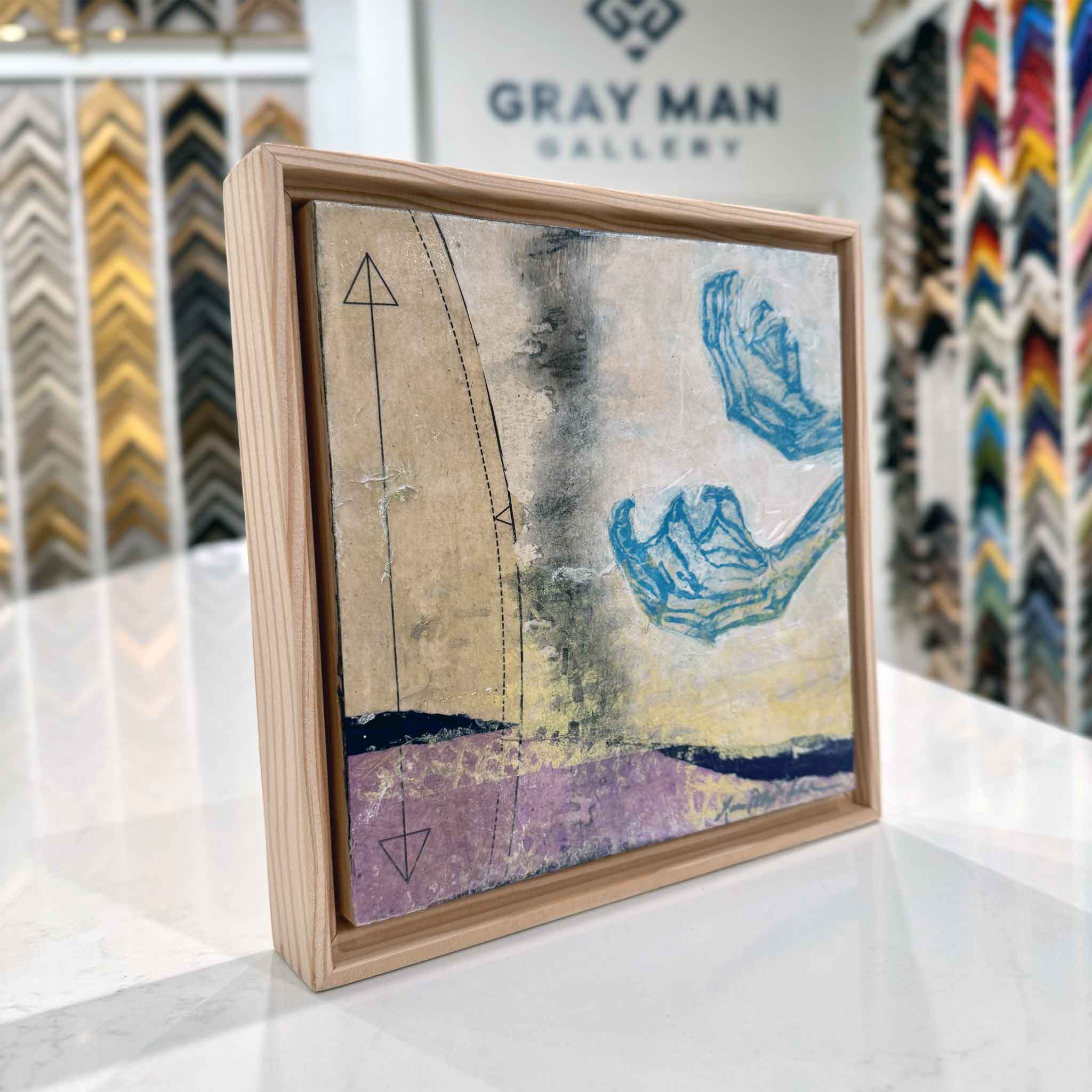 Angled view of Laurie McIntosh’s 5A mixed-media artwork showing the rustic wooden floater frame and surface texture.