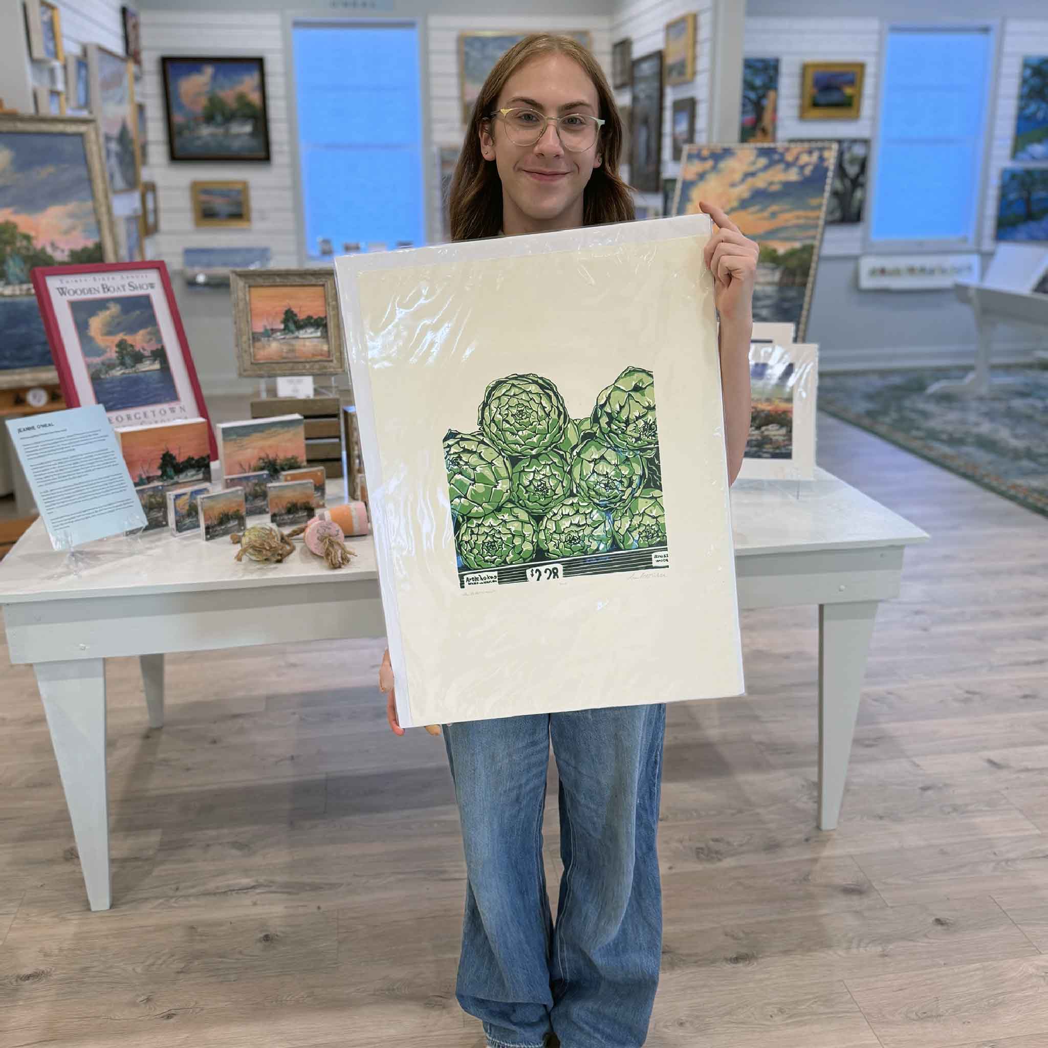 “Wally’s Artichokes” original linocut by Laurie McIntosh held at Gray Man Gallery, featuring vibrant green artichokes in bold hand-carved detail.