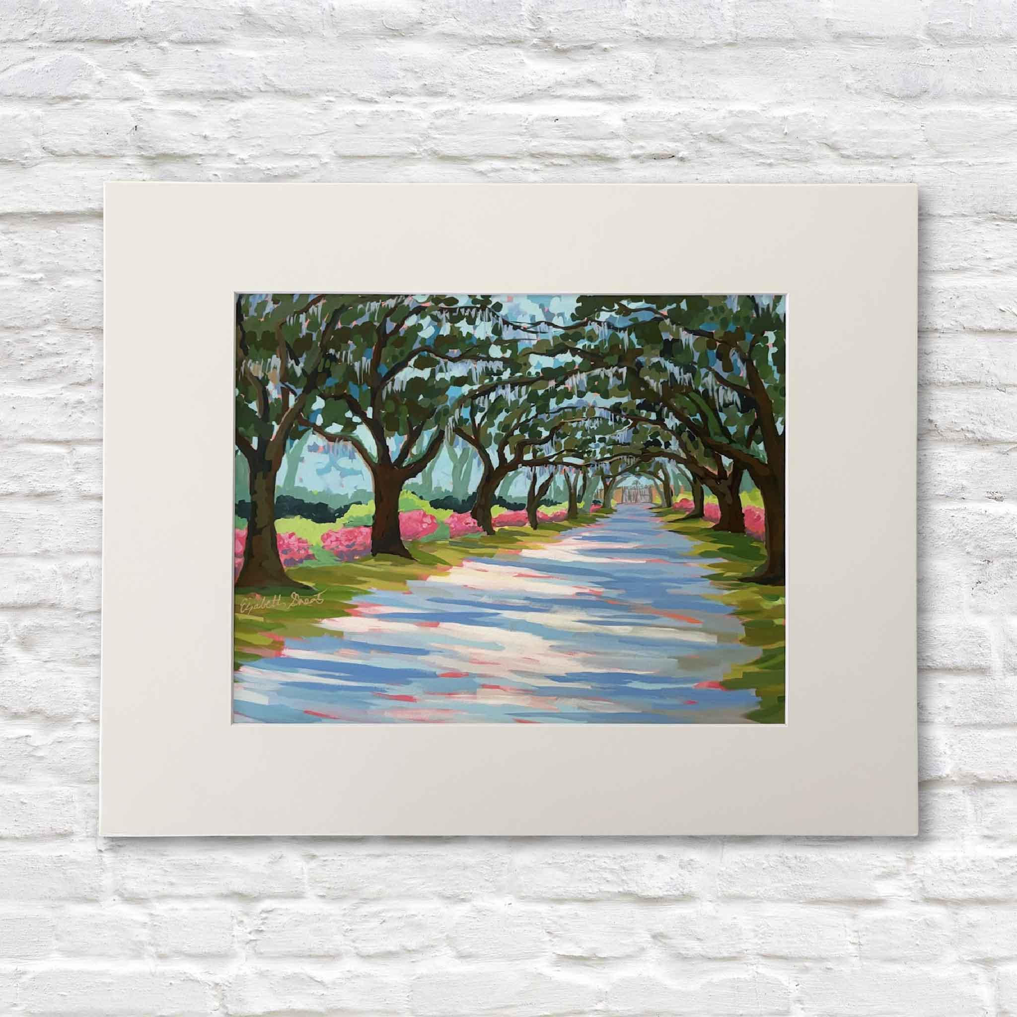 Elizabeth Sheats Litchfield Canopy in Spring fine art giclée print on display at Gray Man Gallery in Pawleys Island South Carolina, featuring live oak canopy at Litchfield Plantation with Spanish moss, azaleas, spring colors, and Lowcountry coastal landscape artwork, matted to fit standard 11x14 and 16x20 frames