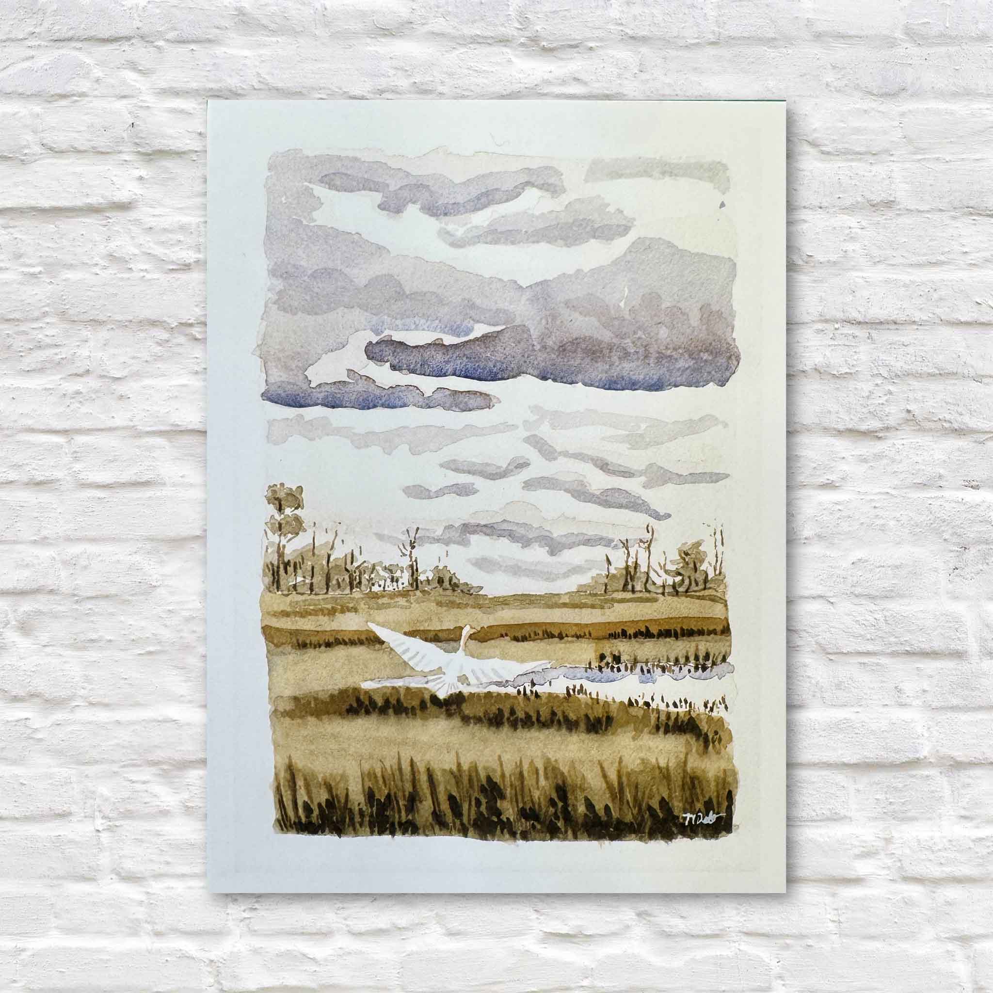 Heron Taking Flight 5x7 print by local artist Maggie Pelton featuring a white heron lifting from a Lowcountry marsh beneath a dramatic coastal sky. Available at Gray Man Gallery in Pawleys Island, South Carolina.