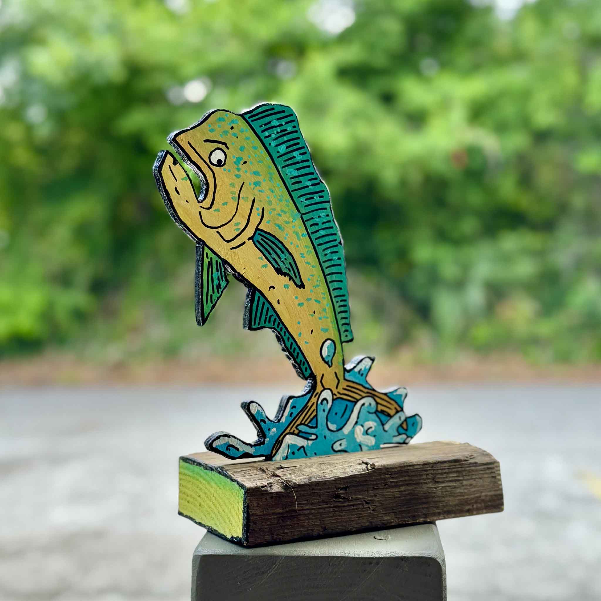 Close-up detail of Mahi Mahi Mahi Mahi by Charleston artist Nick Kawczynski, showing the hand-painted mahi-mahi, carved marine-grade plywood construction, and reclaimed wood base. Crafted from surplus materials donated through the Lowcountry Maritime Society and available exclusively at Gray Man Gallery in Pawleys Island, South Carolina.