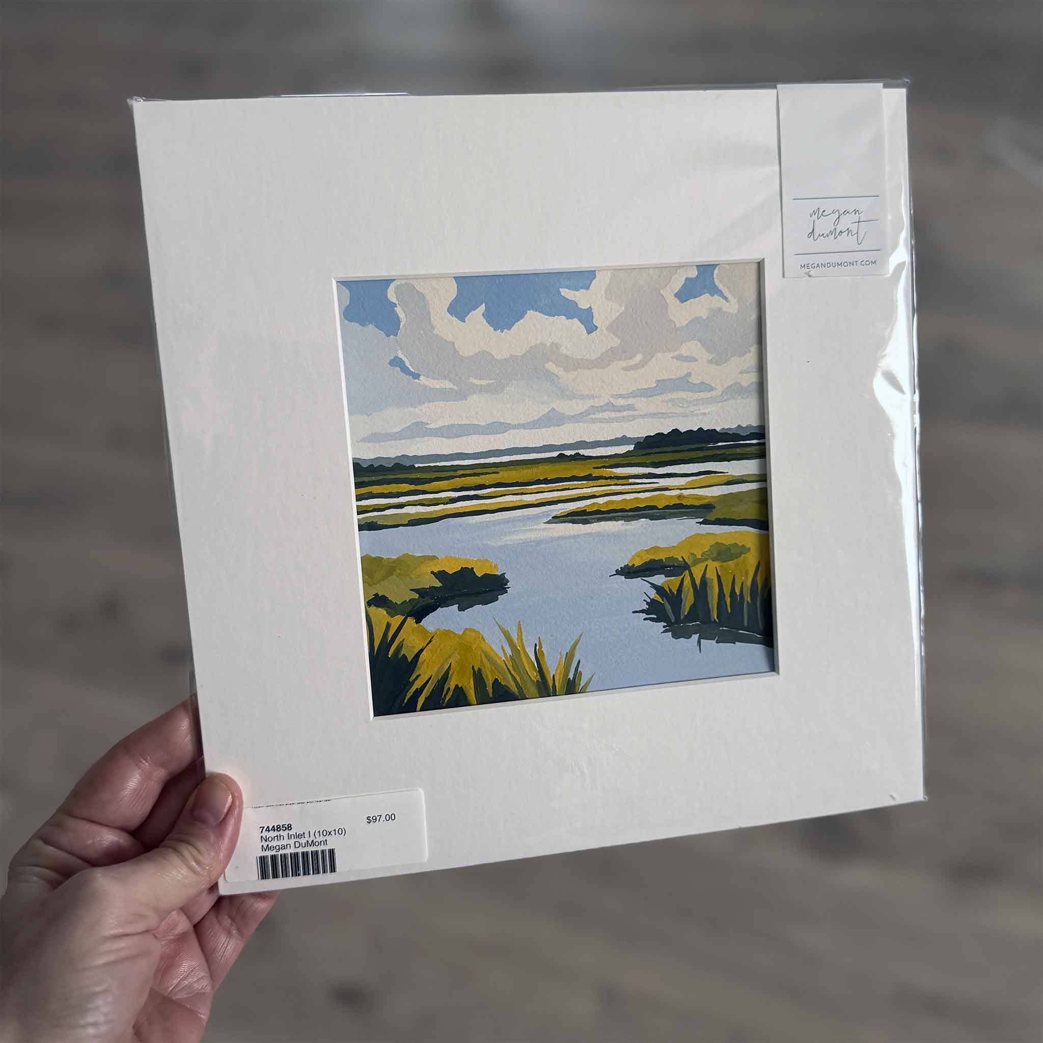 North Inlet I by Megan DuMont — 10x10 gouache painting of the Lowcountry marsh with bold clouds, tidal creeks, and golden spartina, matted for standard framing.