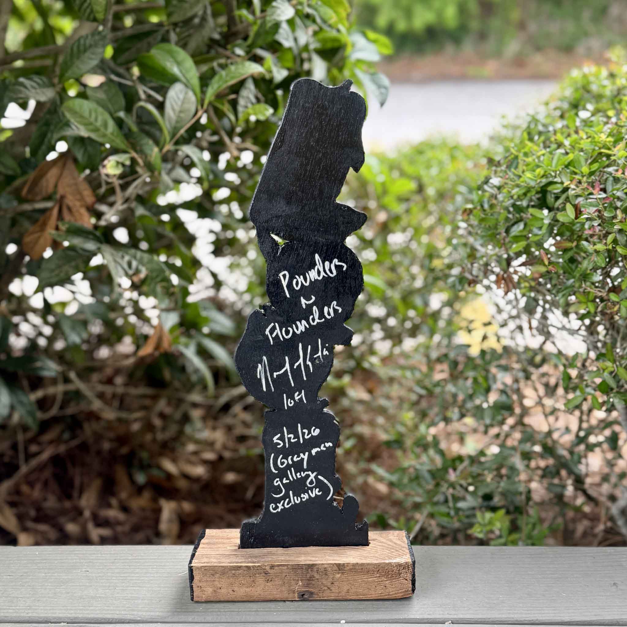 Back view of Poundahs 'n Floundahs by Charleston artist Nick Kawczynski showing the artist's signature, title, date, and Gray Man Gallery exclusive inscription. This one-of-a-kind sculpture is handcrafted from reclaimed marine-grade plywood sourced through the Lowcountry Maritime Society's educational boatbuilding program and available at Gray Man Gallery in Pawleys Island, South Carolina.