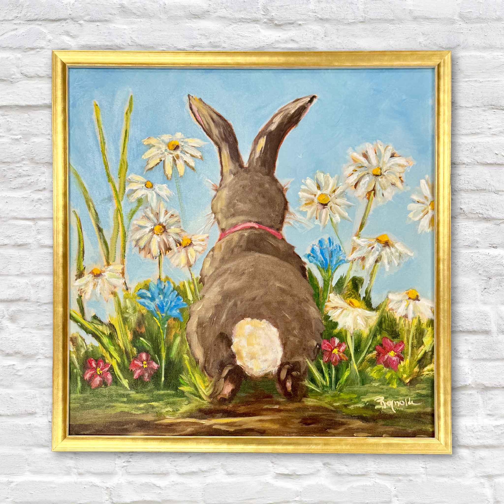 Out of the Rabbit Hole by Jenny Reynolds is an original oil painting featuring an adorable bunny viewed from behind as it sits among blooming white daisies, colorful wildflowers, and lush green grasses beneath a bright blue sky. Professionally framed and available at Gray Man Gallery in Pawleys Island, South Carolina, this whimsical original artwork brings joyful springtime charm to any home.