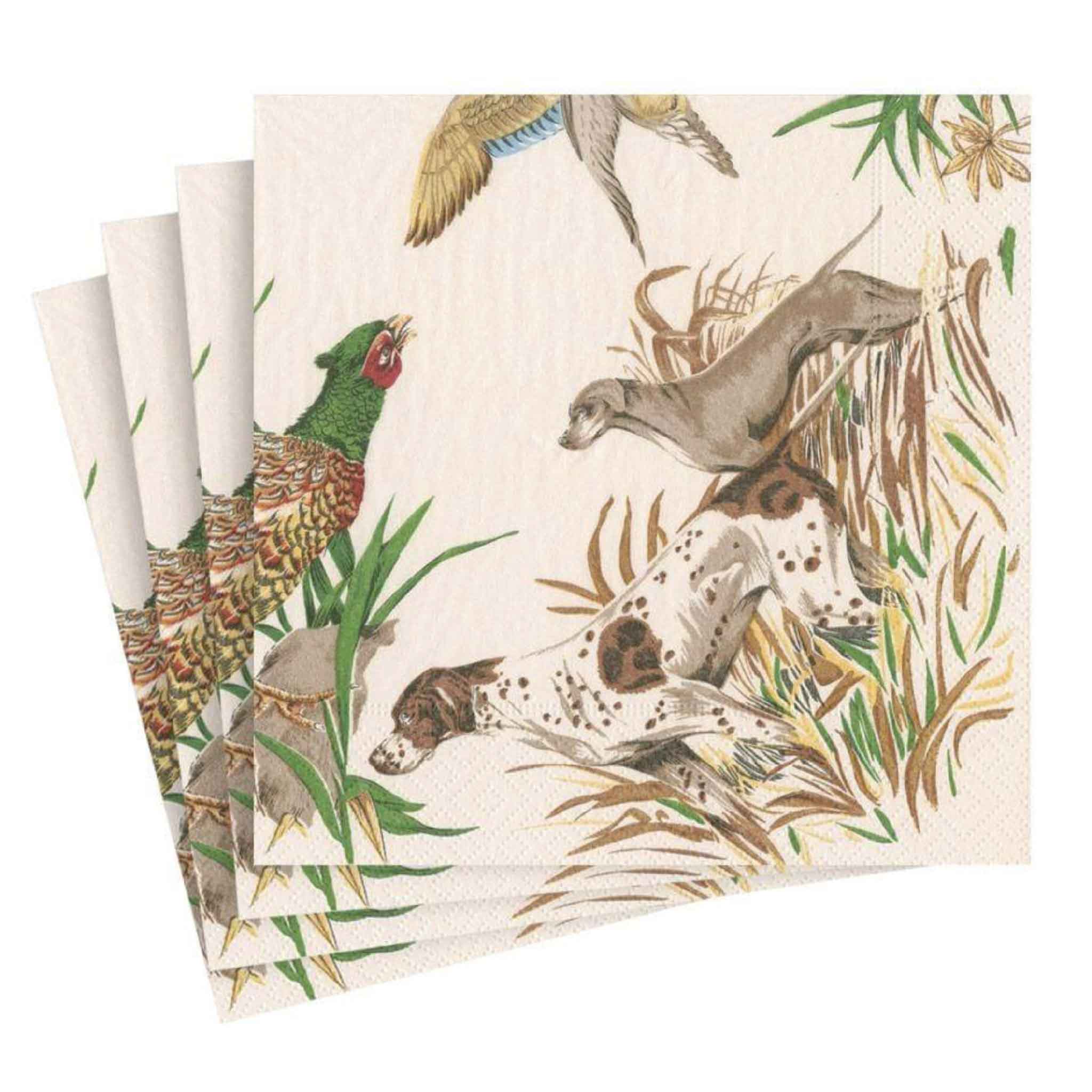 Front view of Pierre Frey Sologne Luncheon Napkins by Caspari featuring beautifully illustrated English pointer hunting dogs flushing a pheasant through tall grasses beneath birds in flight. This elegant European sporting design blends classic country style with fine art, making these premium triple-ply paper luncheon napkins a sophisticated choice for hunting lodges, sporting homes, fall entertaining, and everyday dining. Available at Gray Man Gallery in Pawleys Island, South Carolina.