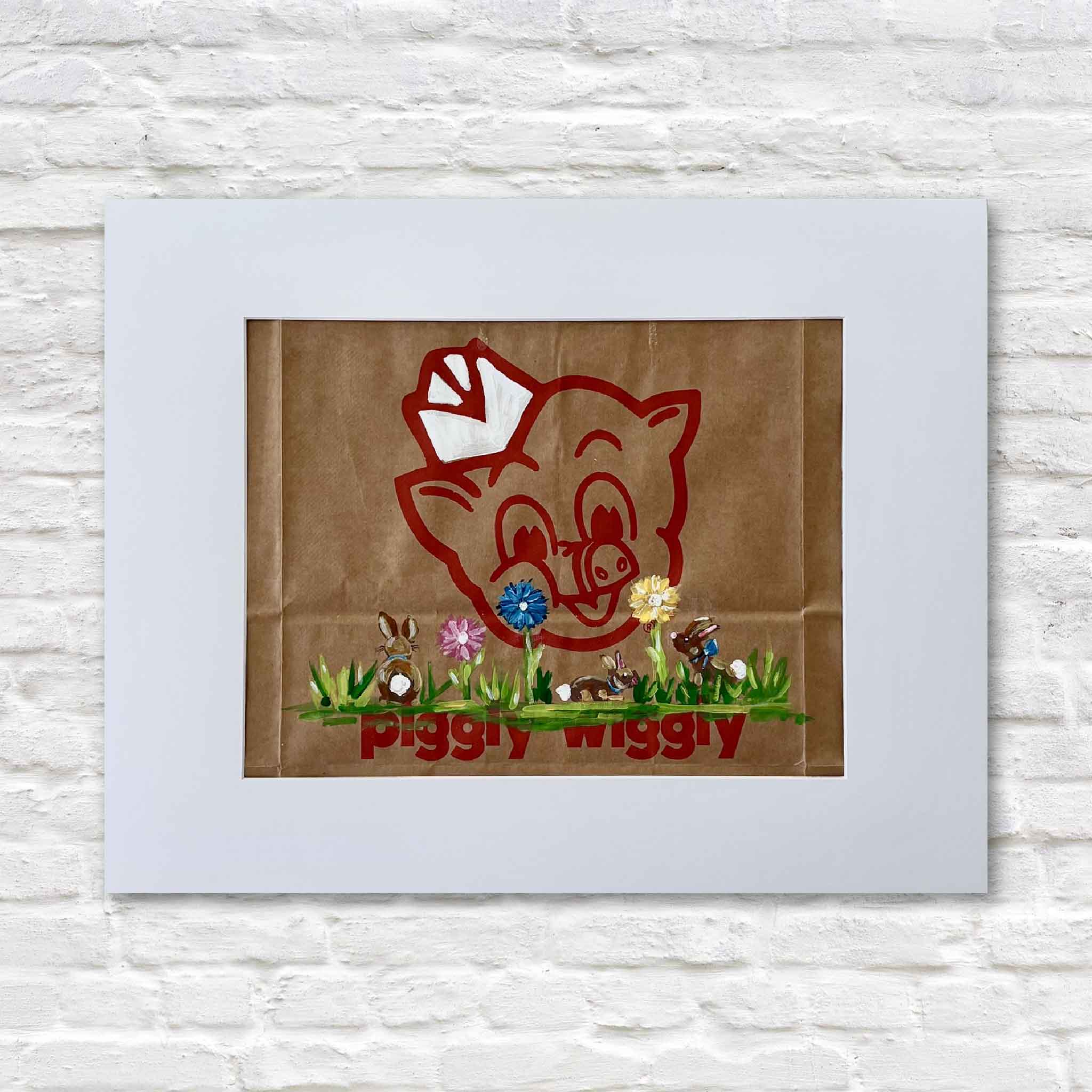 Piggly Wiggly Chocolate Bunnies painting by local artist Jenny Reynolds on an authentic grocery bag featuring pig logo, flowers, and bunny figures at Gray Man Gallery