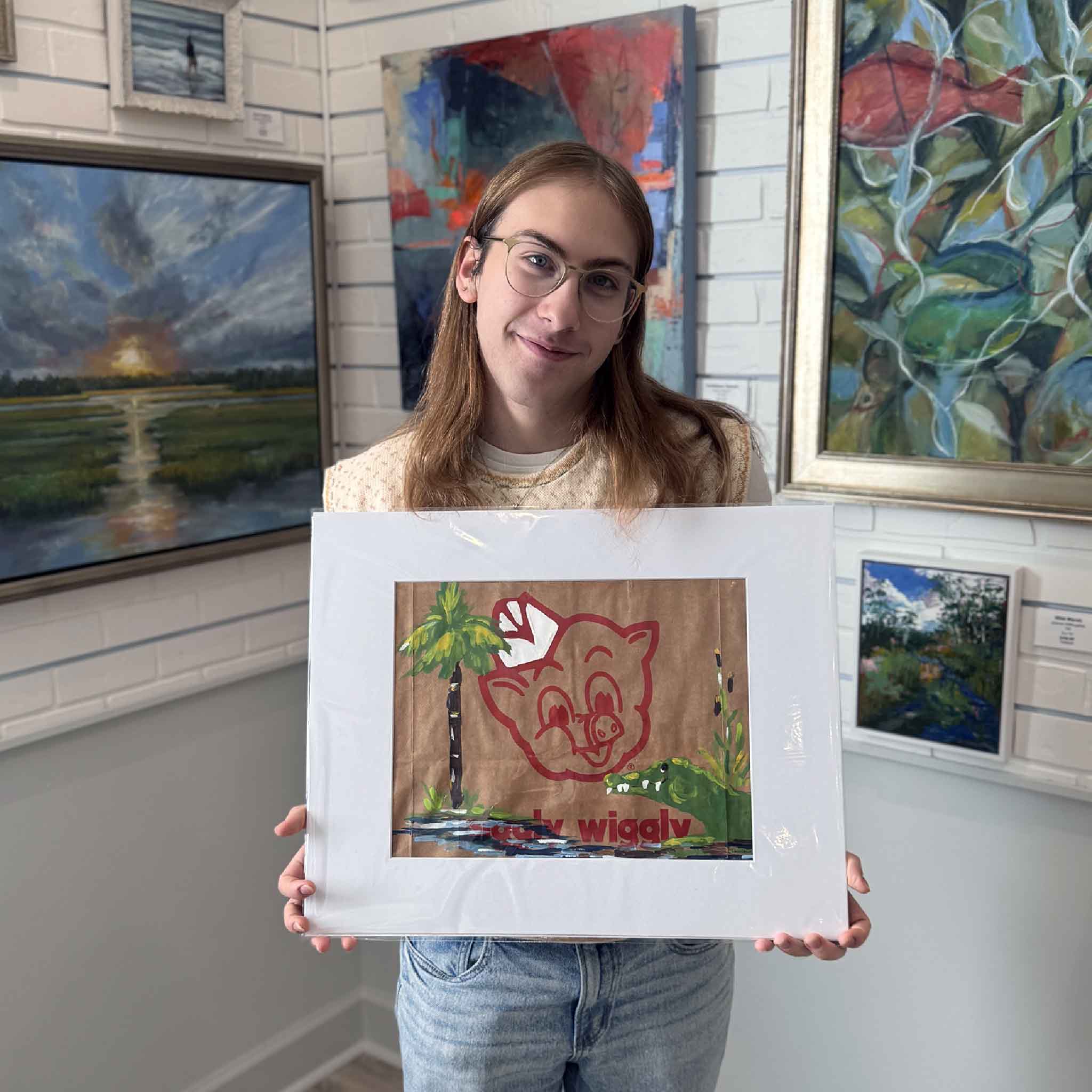 Gray Man Gallery team member holding the Palmetto Gator artwork for size reference.