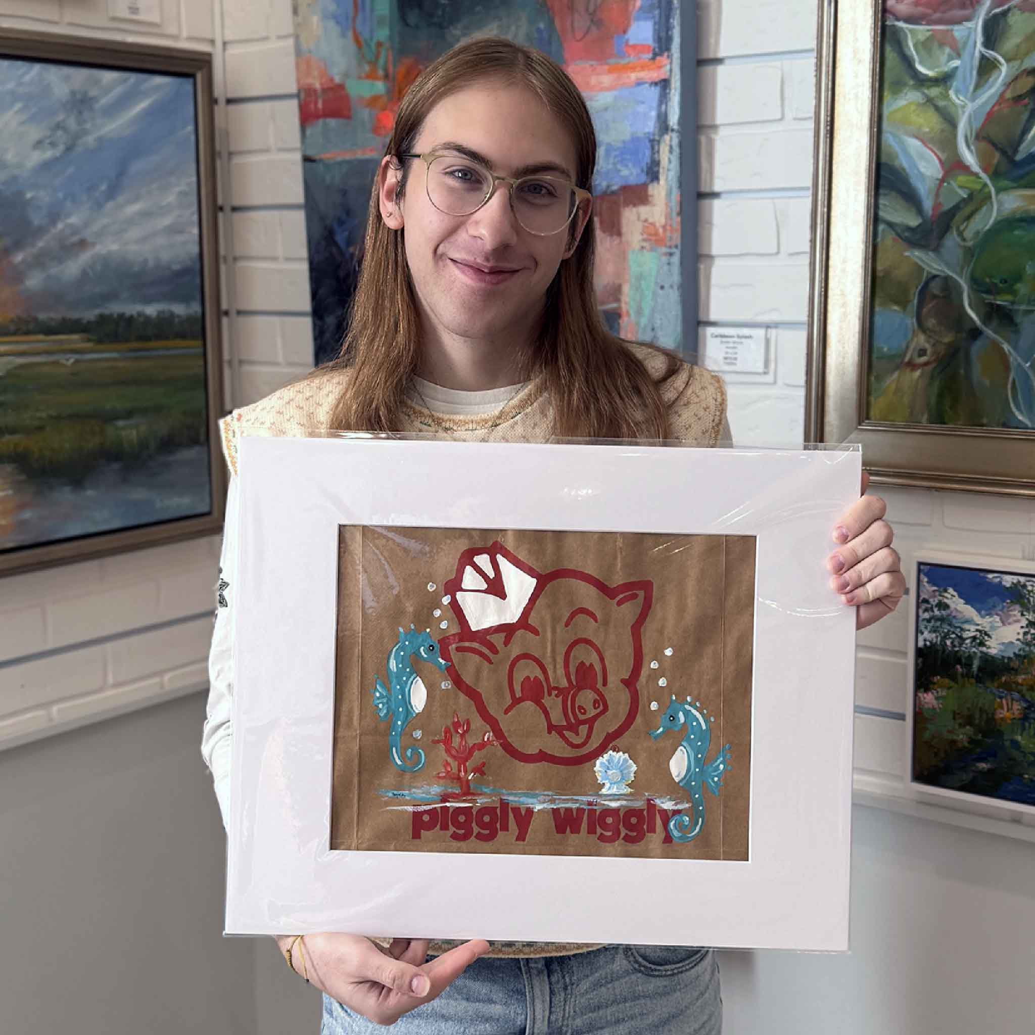 Original coastal artwork by Jenny Reynolds with seahorses and shells surrounding the Piggly Wiggly mascot, displayed in bright gallery lighting.