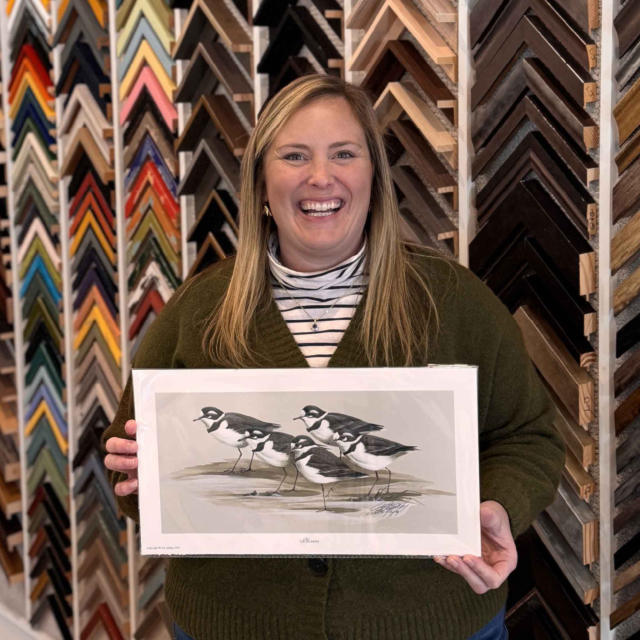 “Plovers,” a signed and numbered wildlife art print by Art LaMay, shown held inside Gray Man Gallery to demonstrate scale, paper quality, and presentation, photographed in Pawleys Island, South Carolina