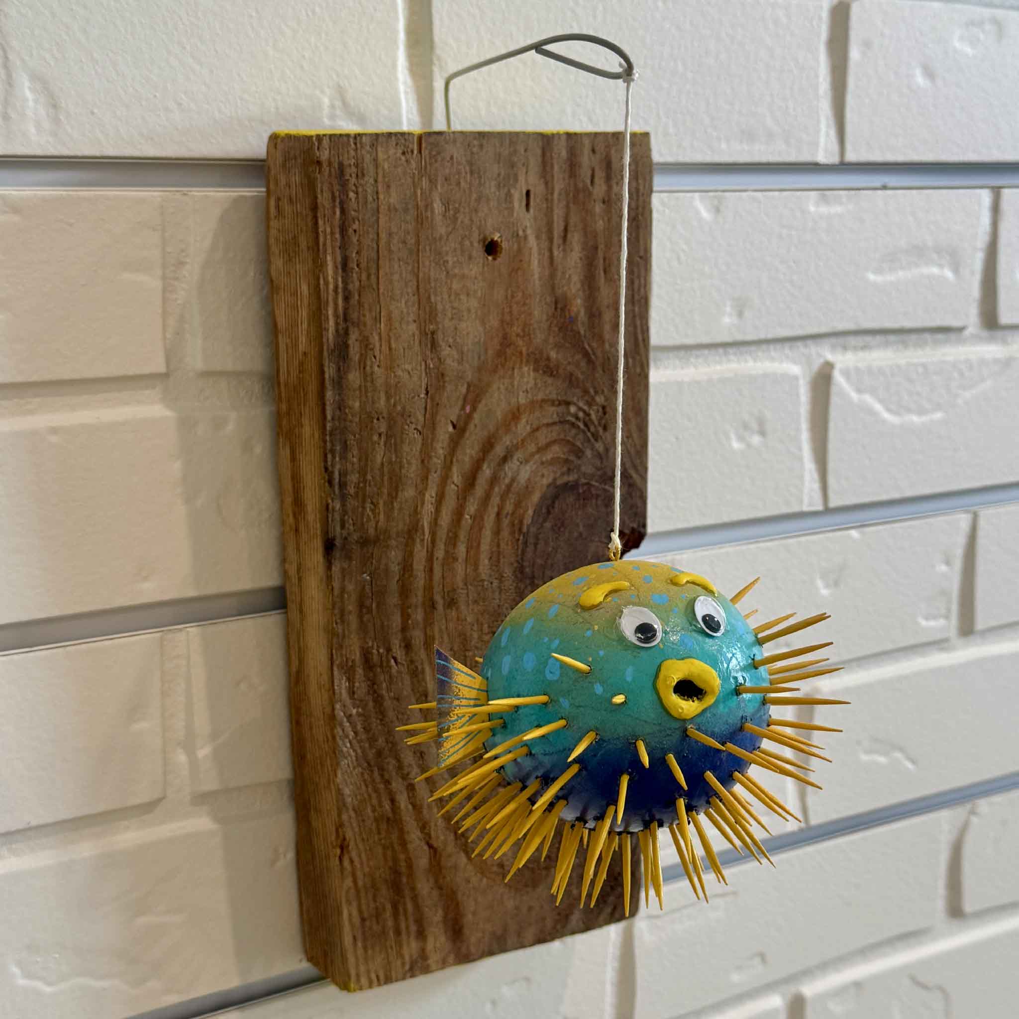 Side view of Pufferfish #18, an original mixed media wall sculpture created exclusively for Gray Man Gallery by Charleston artist Nick Kawczynski and displayed at Gray Man Gallery in Pawleys Island, South Carolina.