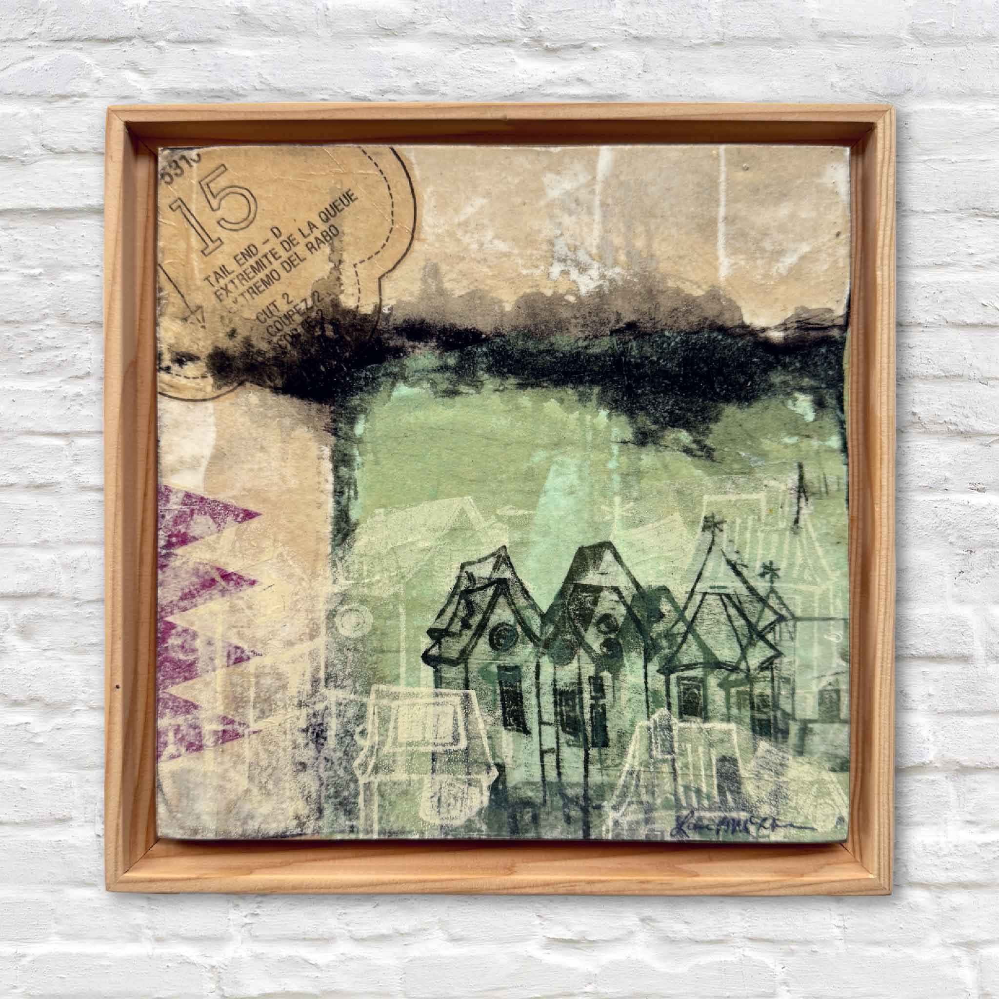 Mixed-media artwork titled 6A by Laurie McIntosh framed in a rustic wood floater frame, showing layered textures and abstract village imagery.