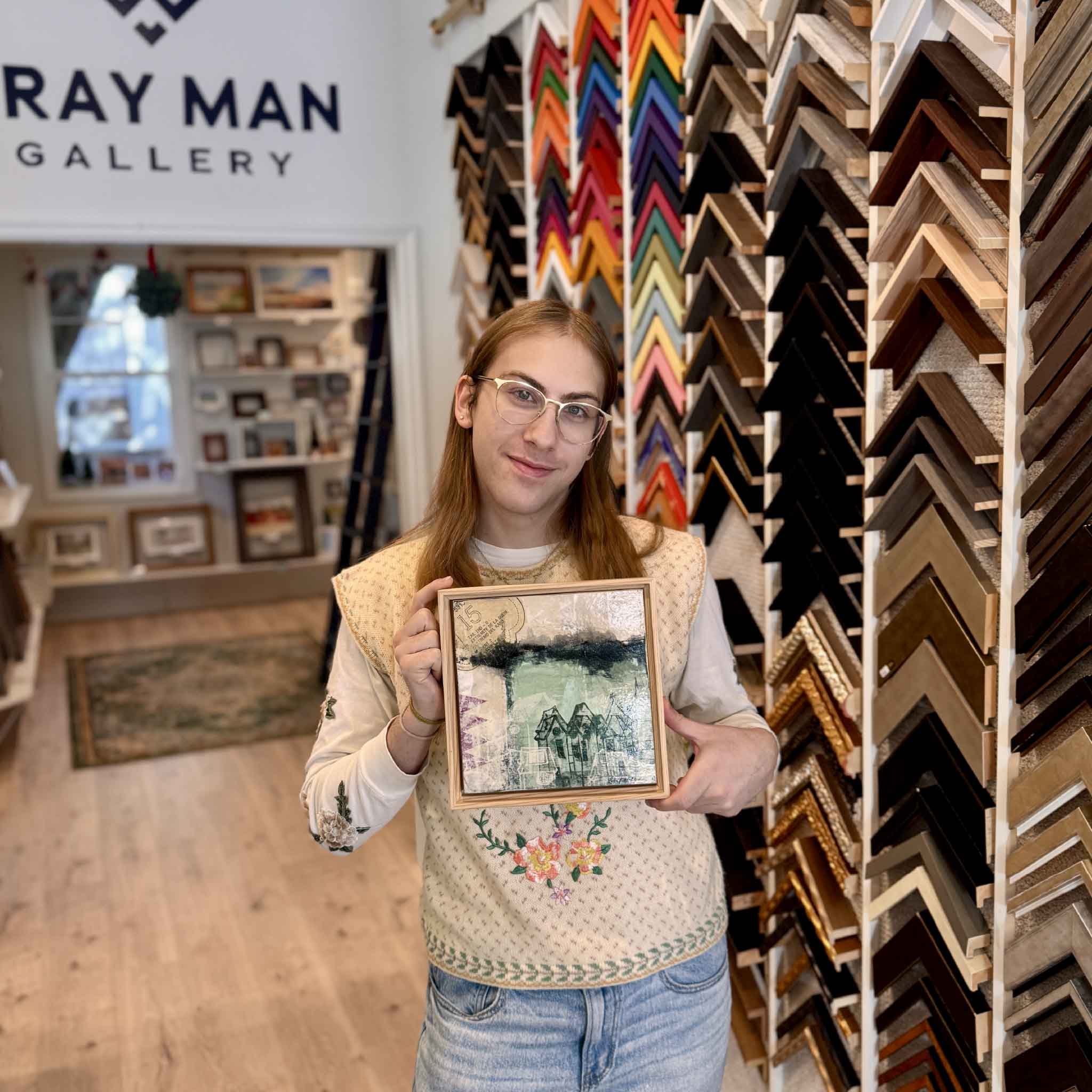 Gallery team member holding the artwork 6A by Laurie McIntosh to show scale in the Gray Man Gallery.