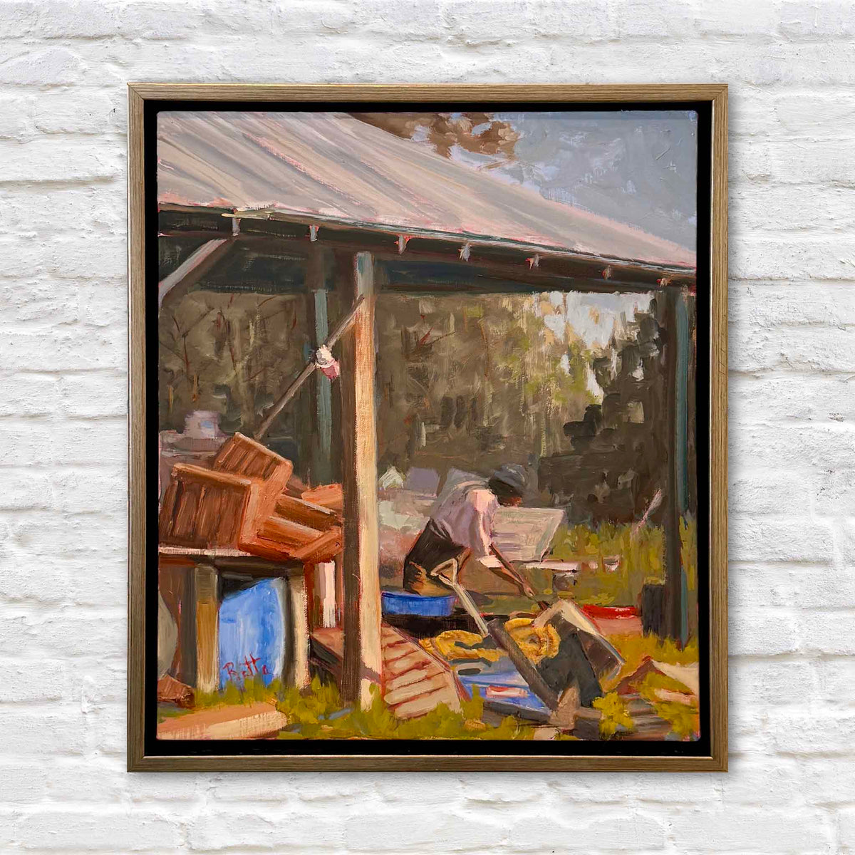 Oyster Shoveler #220 original oil painting by local artist Retta Dotterer depicting a Lowcountry oyster worker shoveling beneath a rustic shed surrounded by tools and oyster-working equipment, framed and available at Gray Man Gallery in Pawleys Island, South Carolina.