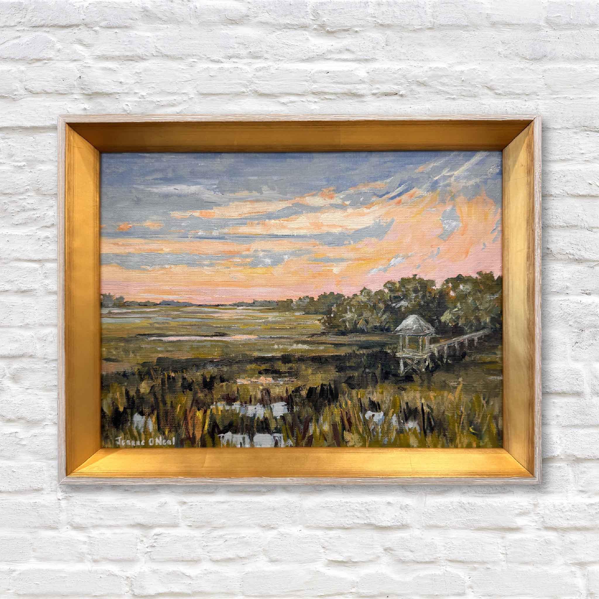Original oil painting “Salt + Light #3” by Jeanne O’Neal in gold frame, featuring a Lowcountry marsh sunset with peach and gold sky, displayed at Gray Man Gallery in Pawleys Island South Carolina