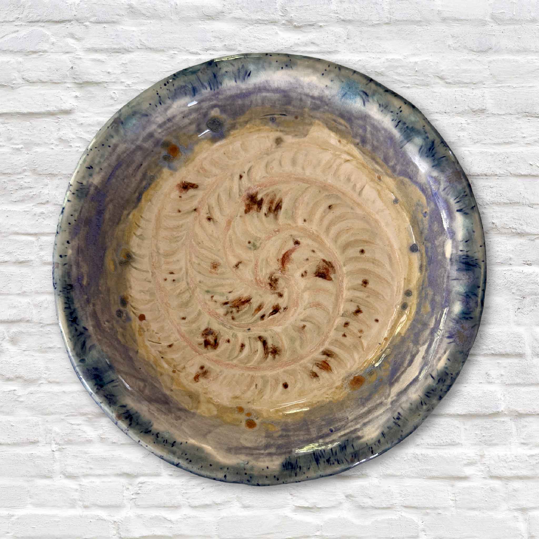 Hand-carved Sea Life Spiral Dish by local artist Vida Miller featuring blue and green coastal glaze, photographed at Gray Man Gallery in Pawleys Island