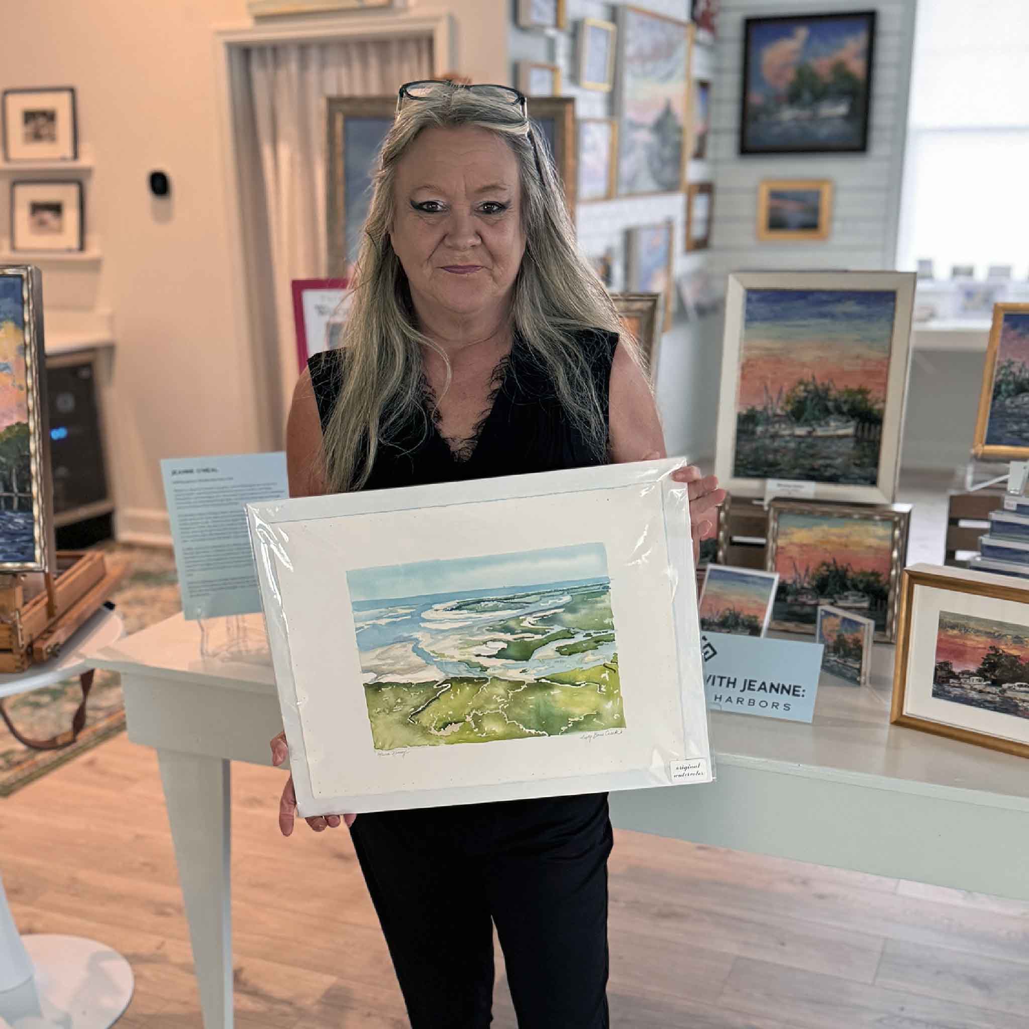 Original watercolor painting Sixty Bass Creek by Maura Kenny featuring North Inlet marsh channels, tidal waterways, and coastal landscape on deckled-edge paper. Pictured at Gray Man Gallery.