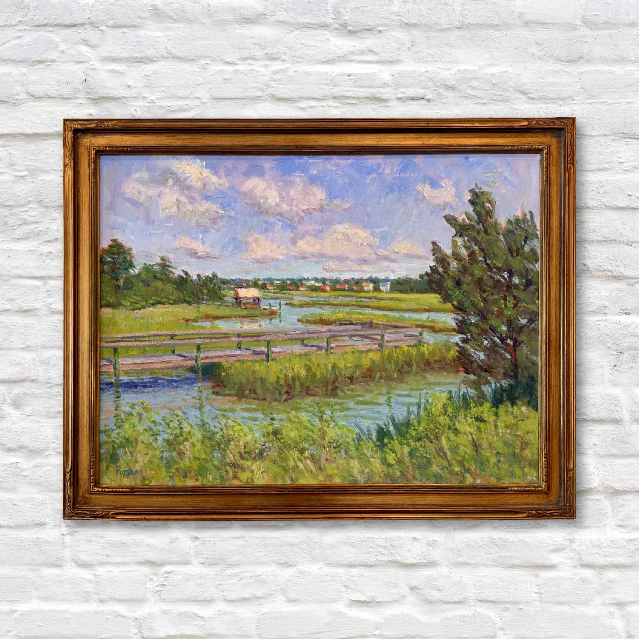 Original oil painting “South Litchfield View” by local artist Michael Rogan showing a Lowcountry marsh, bridge, and tidal creek near Pawleys Island, professionally framed and displayed on the wall at Gray Man Gallery