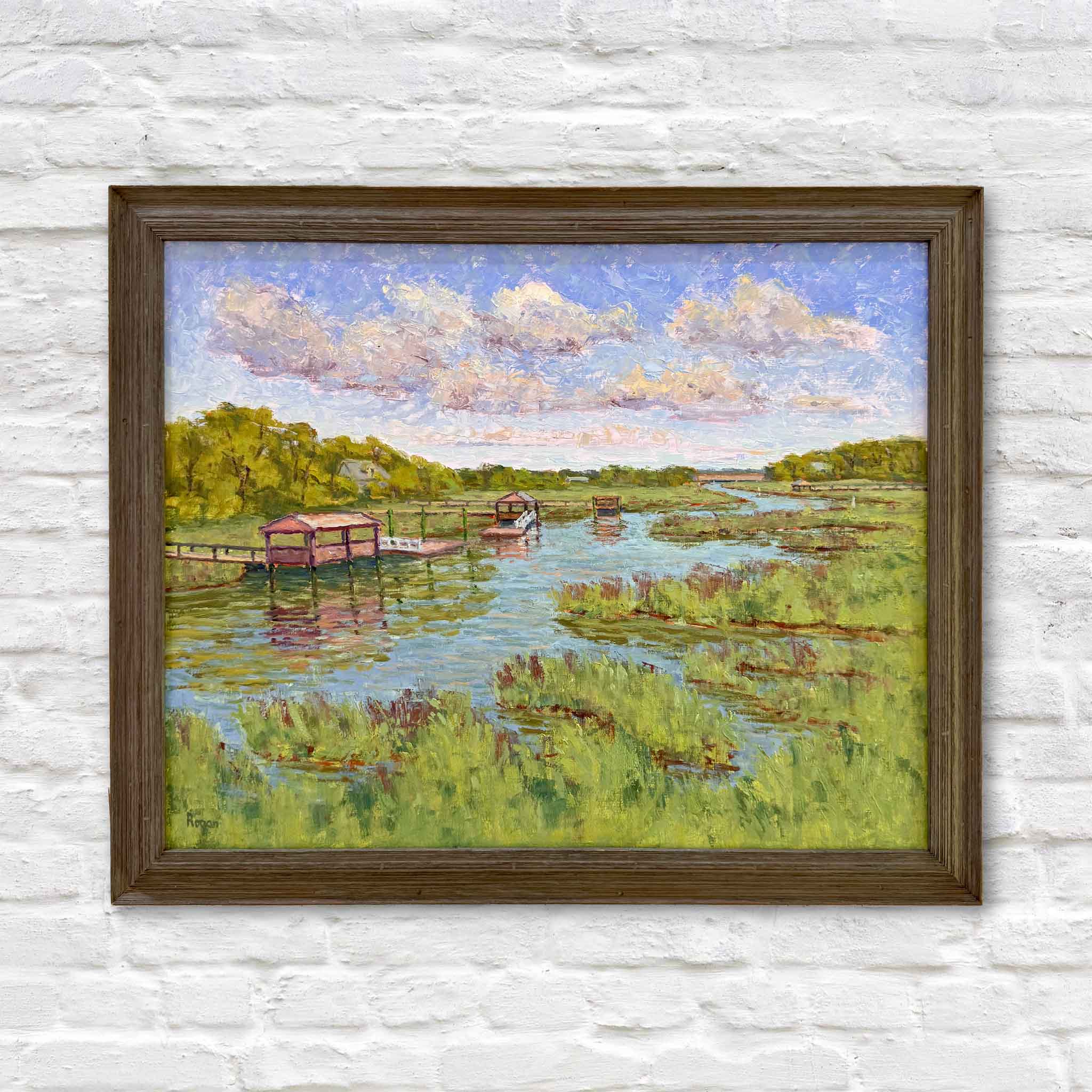Local artist Michael Rogan holding Spring Greens original oil painting at Gray Man Gallery, showing scale of Pawleys Island marsh scene with creek, docks, and vibrant green grasses