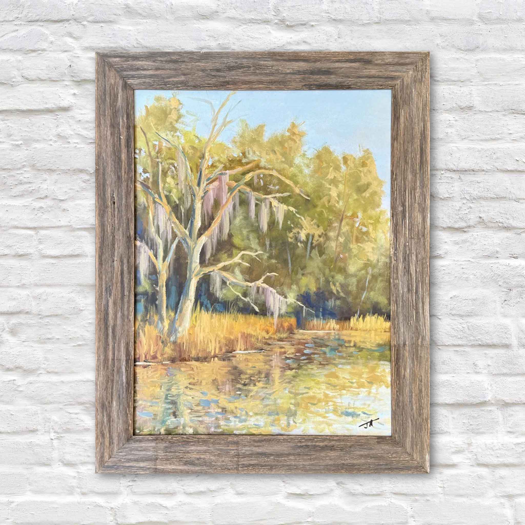Still Waters, an original framed 18×24 oil painting by South Carolina local artist Jamie Arnold, captures a peaceful Lowcountry marsh with Spanish moss, golden grasses, reflective water, and warm morning light. Available at Gray Man Gallery in Pawleys Island.