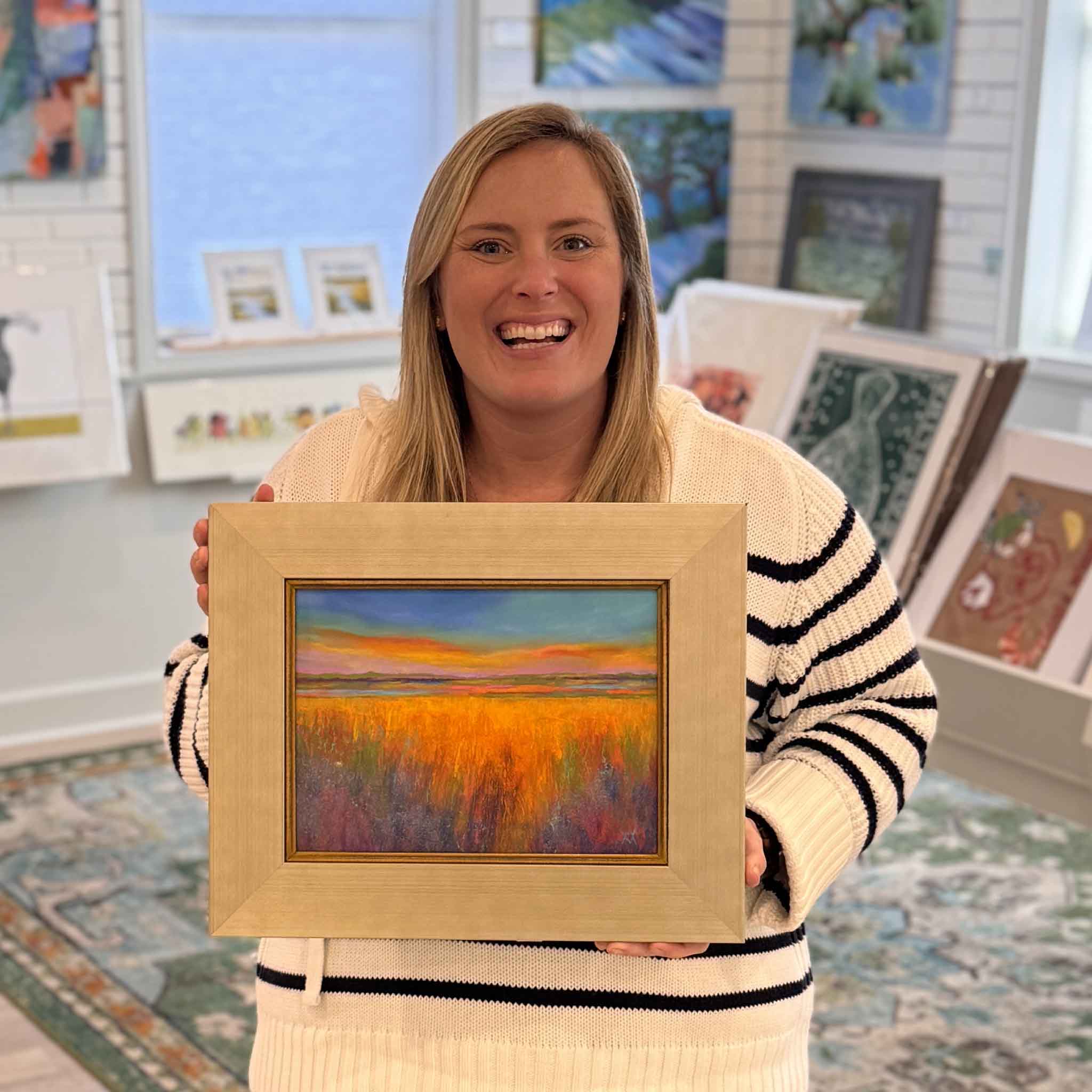 Local artist Vida Miller pastel artwork The Golden Hour shown for scale, held in the gallery space at Gray Man Gallery in Pawleys Island, South Carolina, highlighting the framed original’s size and warm coastal color palette.