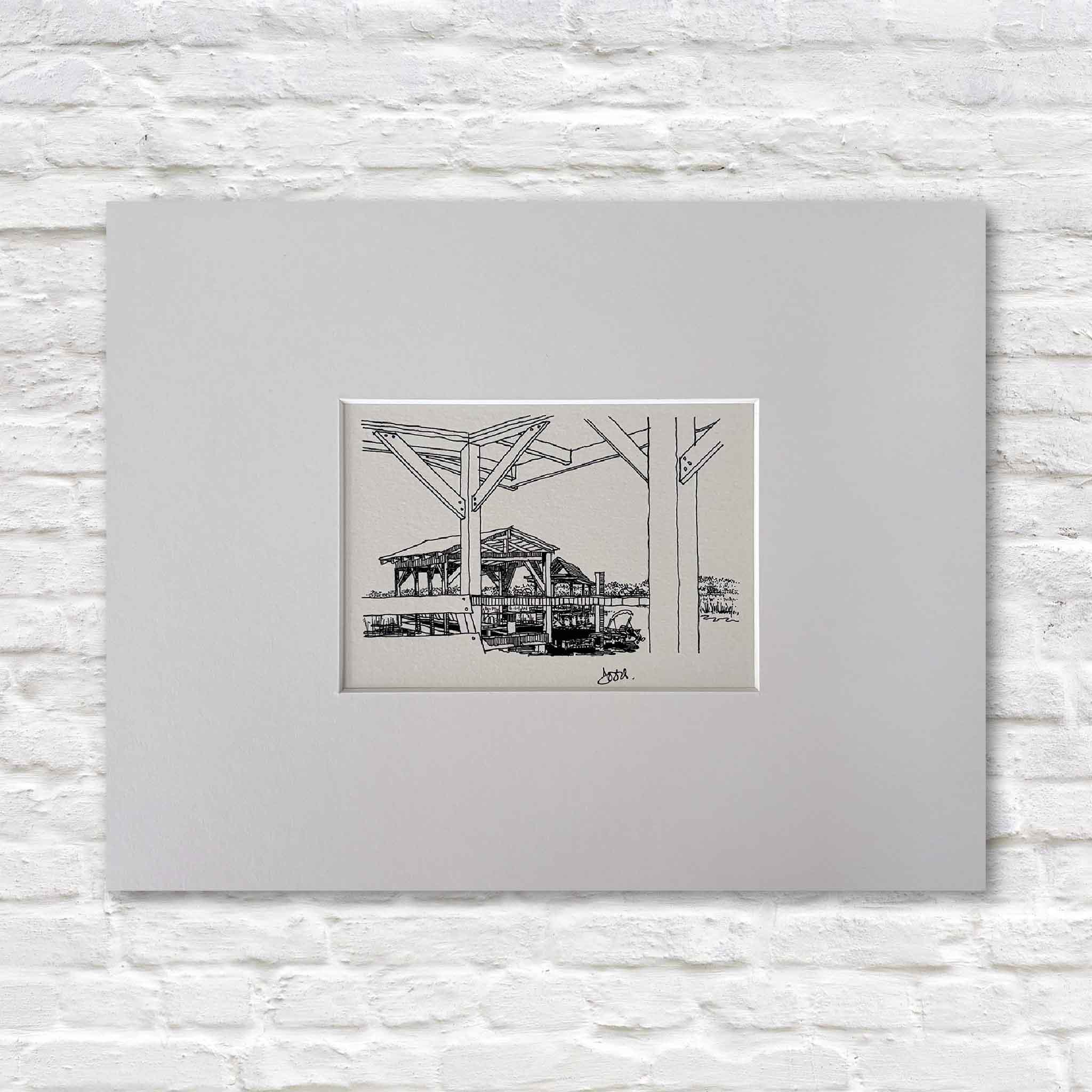 Todd Halamka's "Pawleys Island: Salt Marsh Looking South" pen-and-ink print, professionally matted and available at Gray Man Gallery in Pawleys Island, South Carolina. This detailed Lowcountry drawing looks through the heavy timbers of a dock toward a waterfront pavilion overlooking the salt marsh. Available in standard 8x10 and 11x14 mat sizes that fit ready-made frames without custom framing.