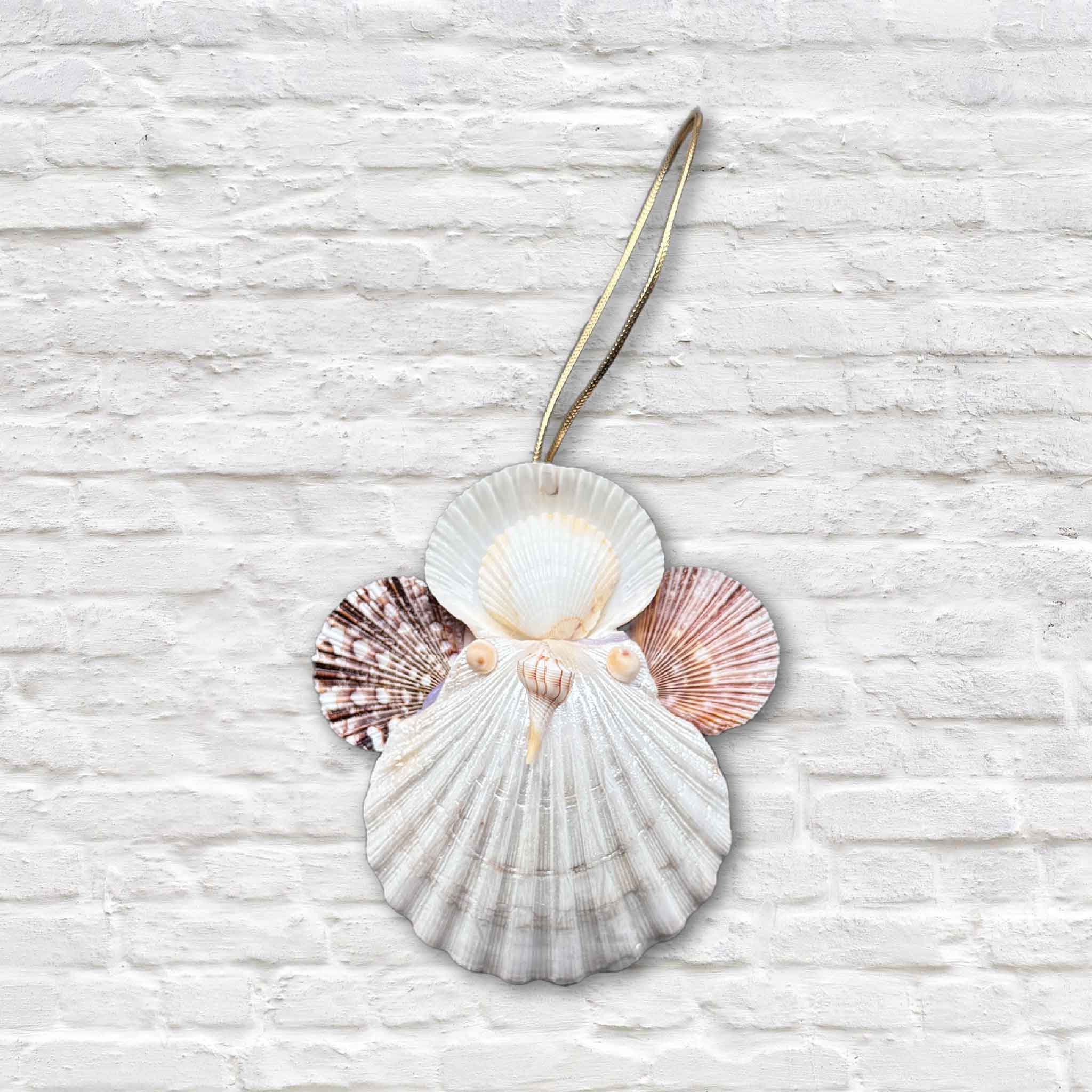 A handcrafted shell angel ornament by Tootsie Watkins, made from layered South Carolina shells with scallop wings and a gold hanging loop.
