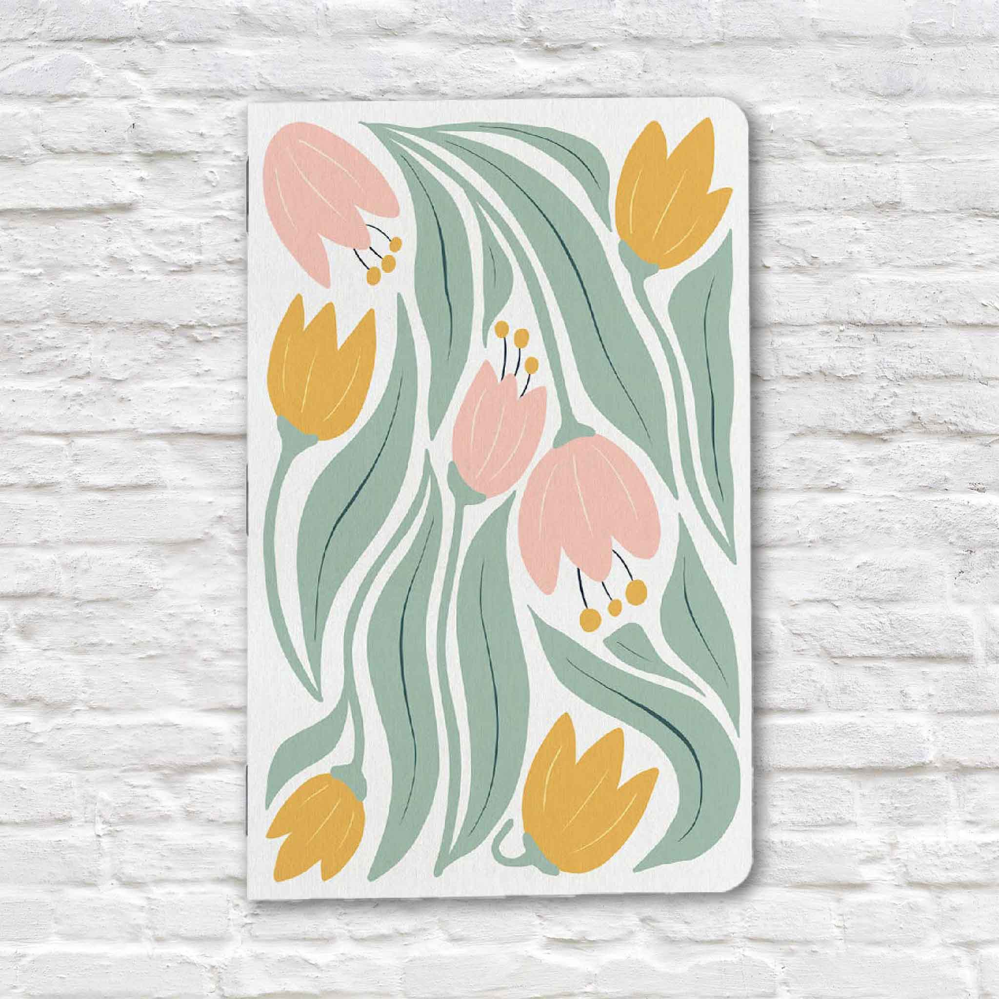 Tulip Floral Notebook by Justin Ryan Books featuring a cheerful pattern of pink and yellow tulips with flowing green leaves. This 5x7 blank notebook is hand-assembled in Austin, Texas and available at Gray Man Gallery in Pawleys Island, South Carolina.