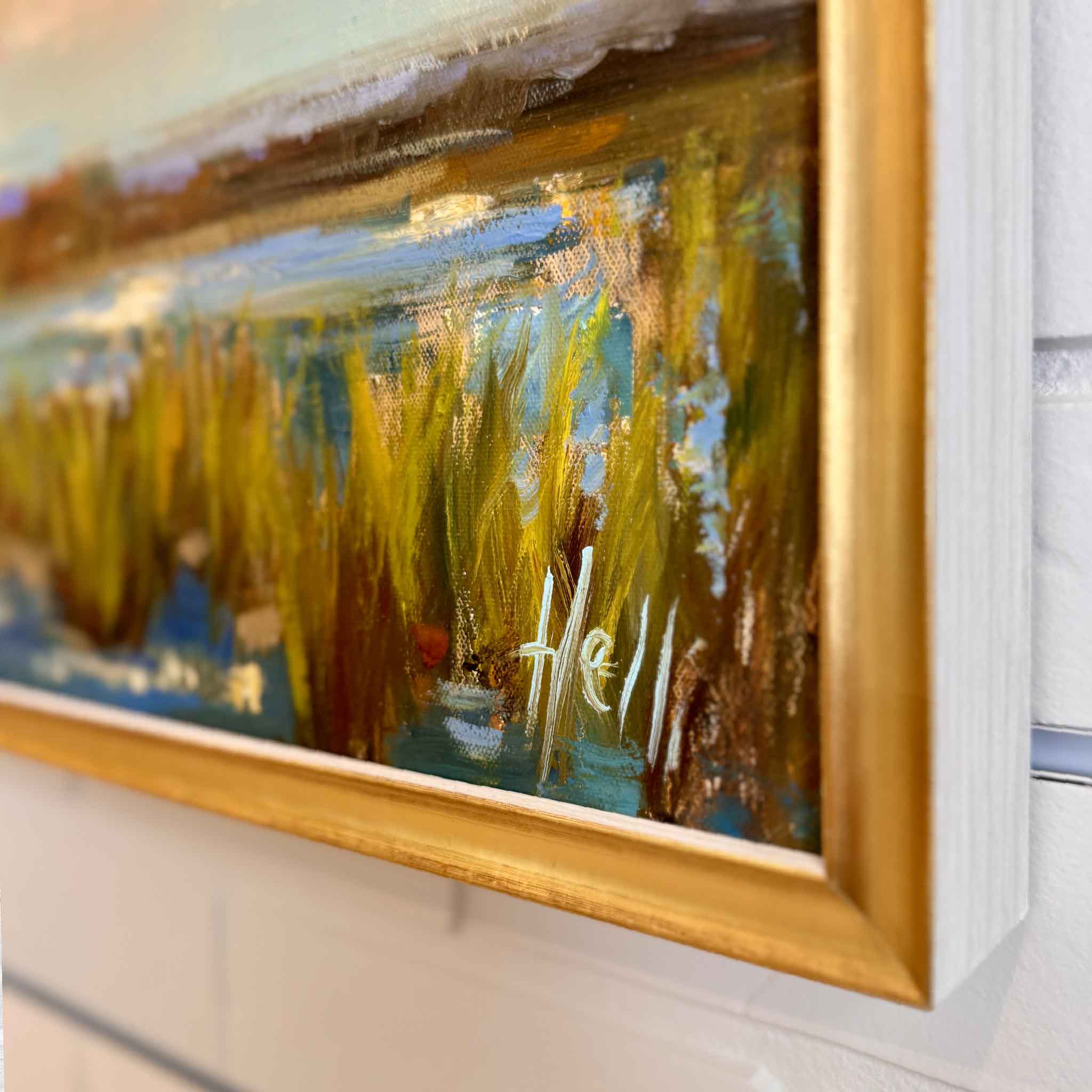 Angled view of Twilight Ballet by local artist Helli Luck, a framed original painting of roseate spoonbills flying over a coastal marsh at sunset, displayed at Gray Man Gallery Pawleys Island