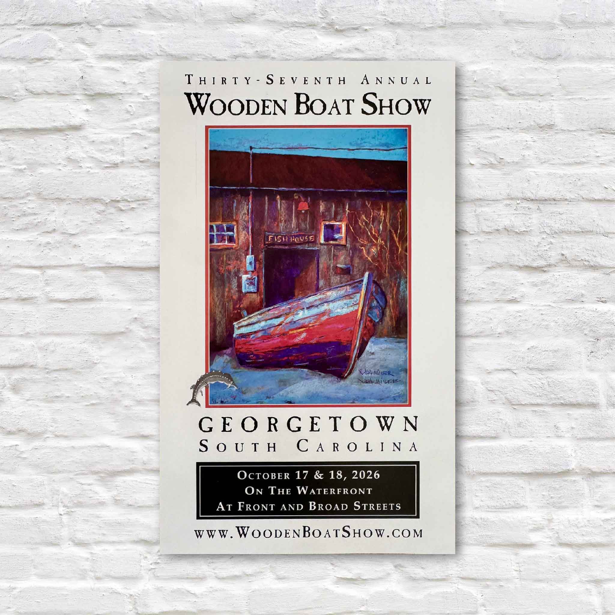 2026 Georgetown Wooden Boat Show limited-edition artist-remarqued poster by South Carolina artist Vida Miller, featuring her painting of the historic Cathou Fish House in Georgetown, SC, with an original hand-painted sturgeon remarque, signed and numbered by the artist and available exclusively at Gray Man Gallery in Pawleys Island.