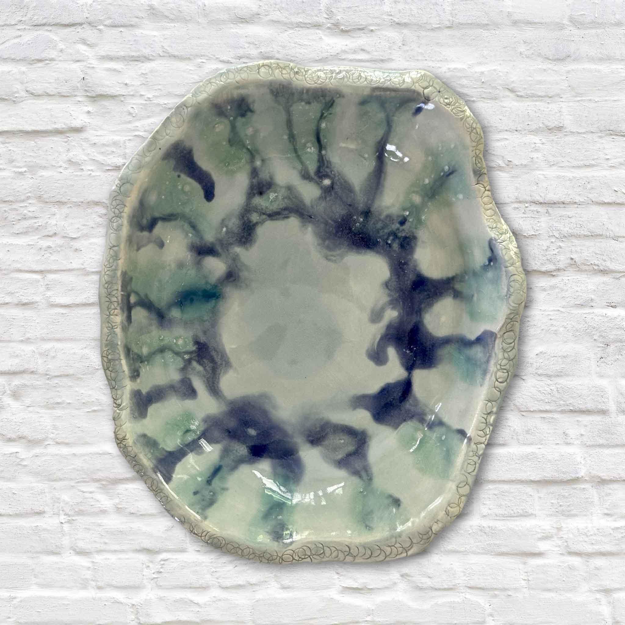 Overhead view of the Marsh Drift Bowl by Vida Miller featuring layered celadon, aqua, and indigo glaze inspired by tidal marshes and shallow coastal water. Handmade pottery available at Gray Man Gallery in Pawleys Island.