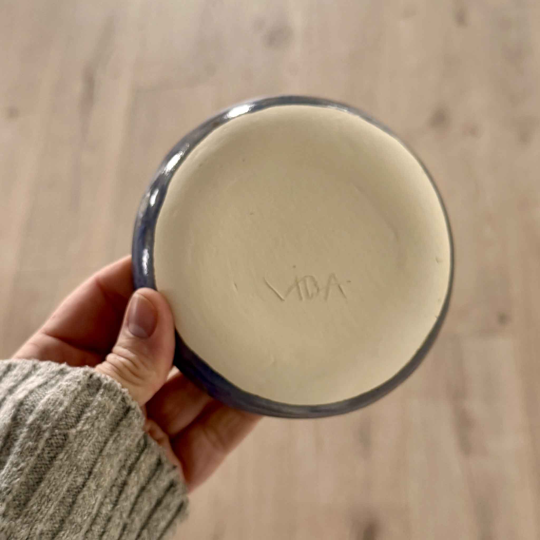 Underside of Pawleys Island Shell Dish – Delft Blue handmade by local Pawleys Island artist Vida Miller, showing her carved signature on the base and deep blue glazed rim, available at Gray Man Gallery in South Carolina