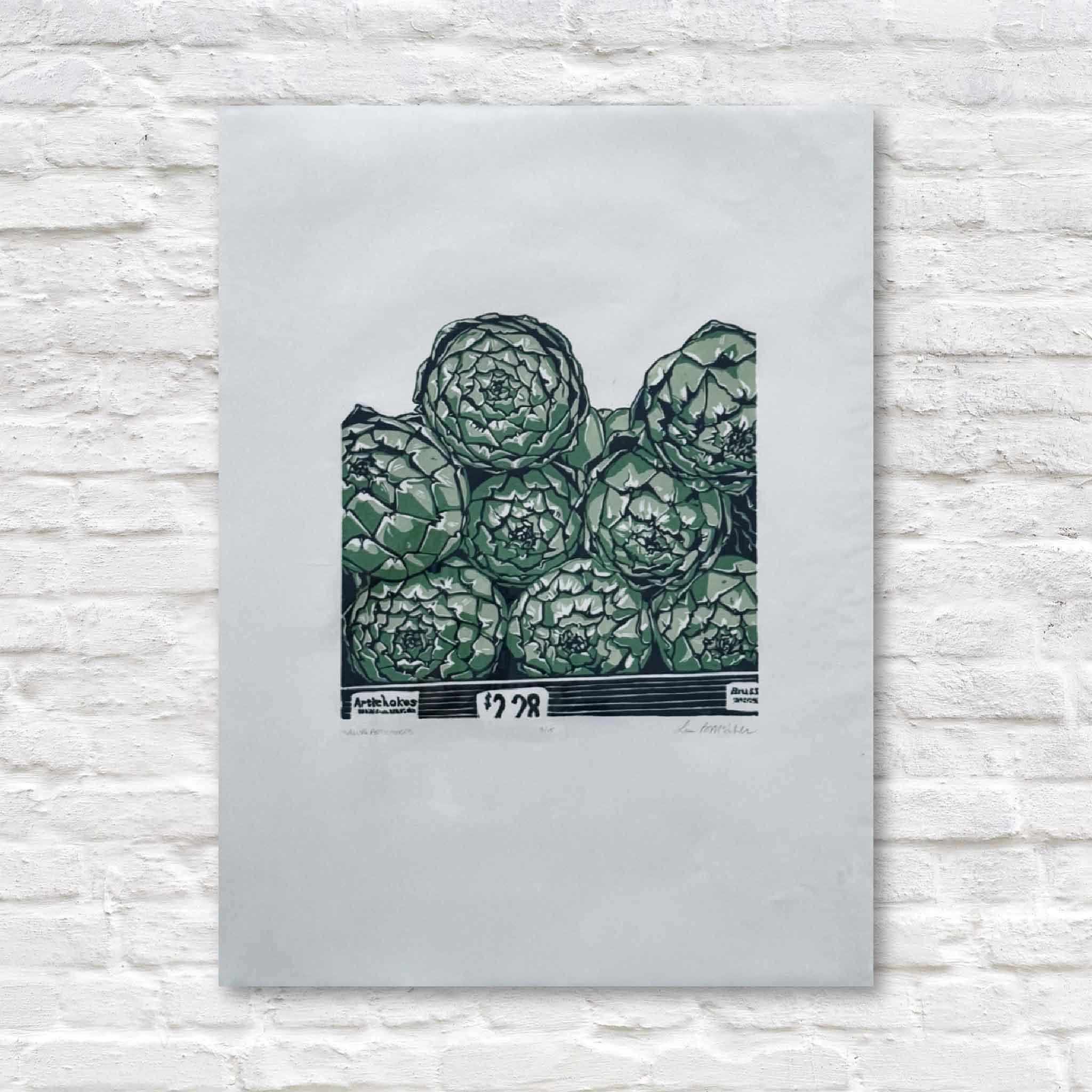 linocut artwork of green artichokes on a light gray background