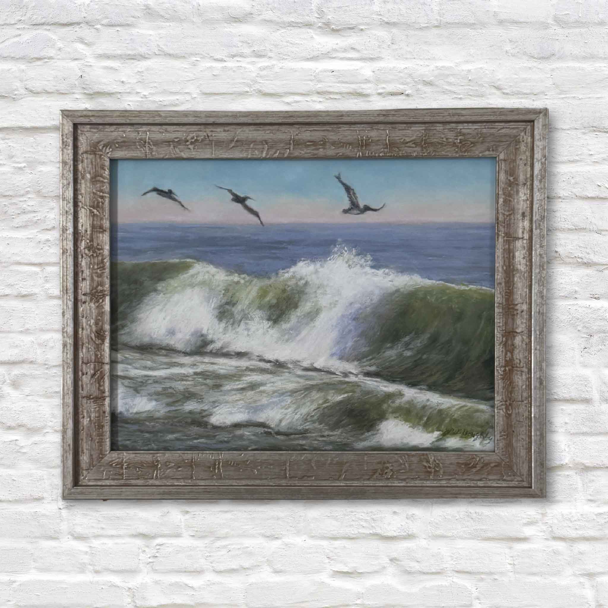 Framed painting of birds over ocean waves on a white brick wall