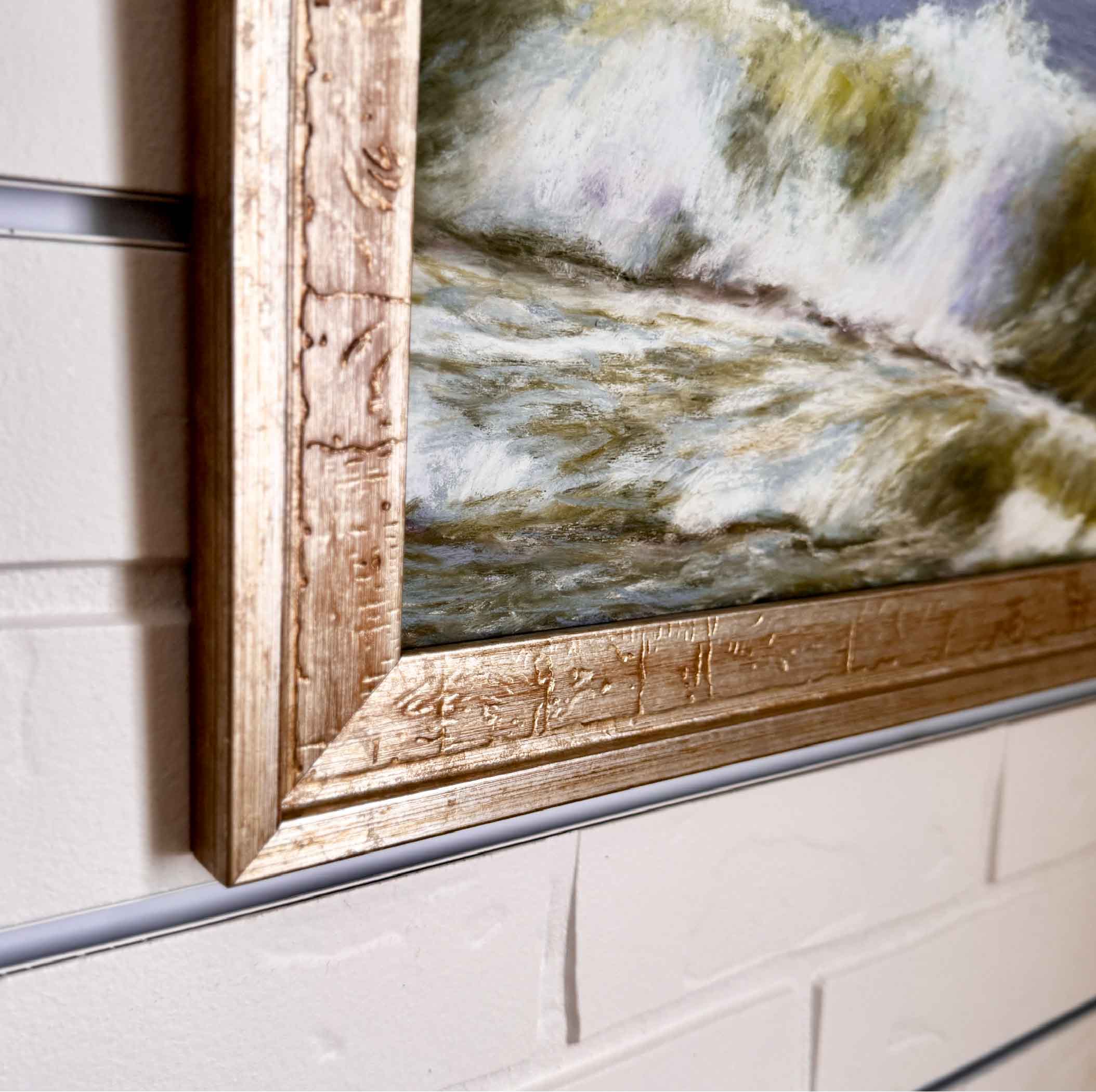 Framed artwork of an ocean landscape with water and sky.