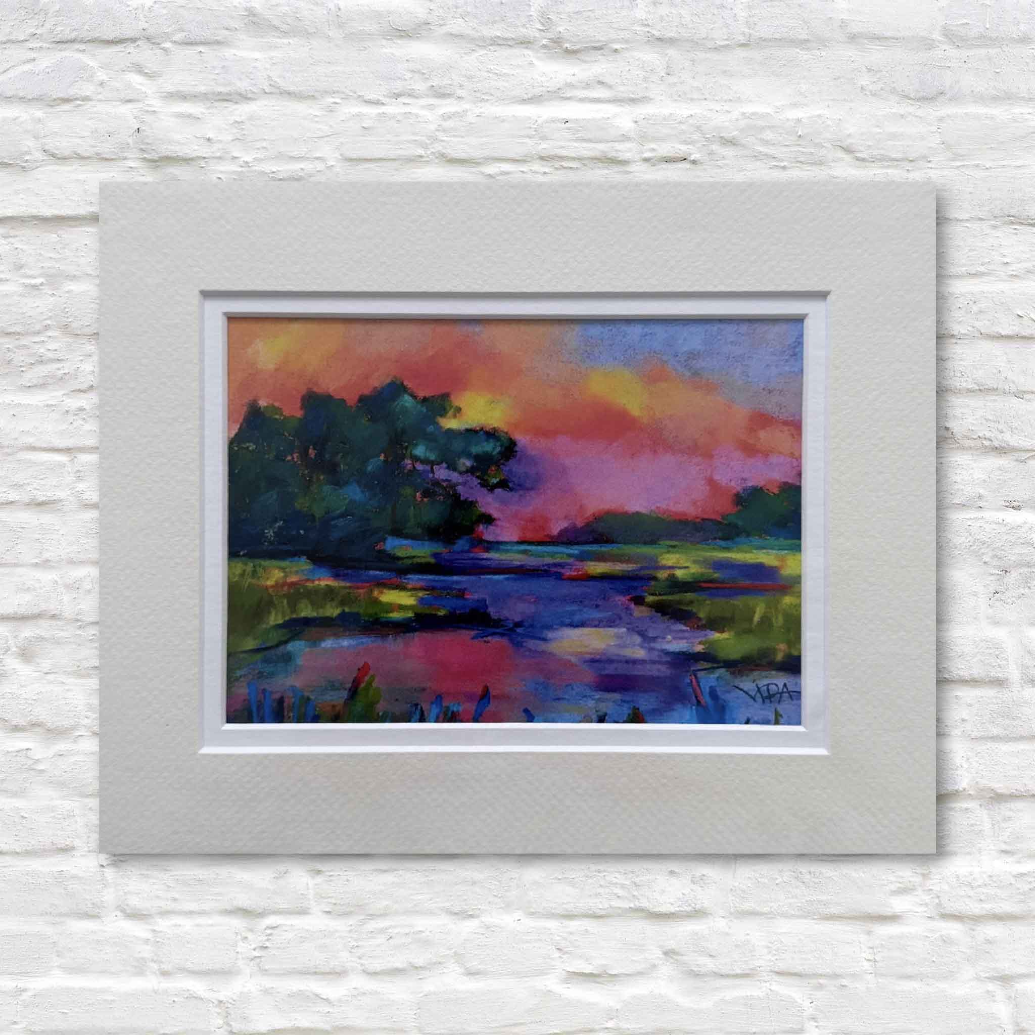 matted abstract landscape painting on a white brick wall