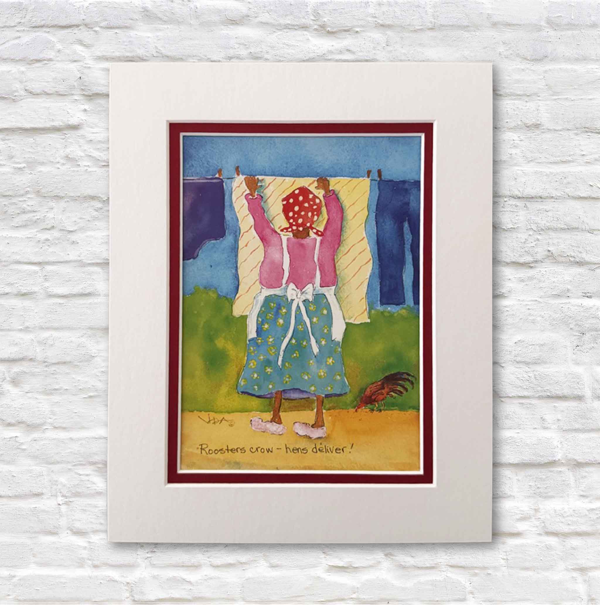 Matted artwork of a woman hanging clothes on a line against a white brick wall.