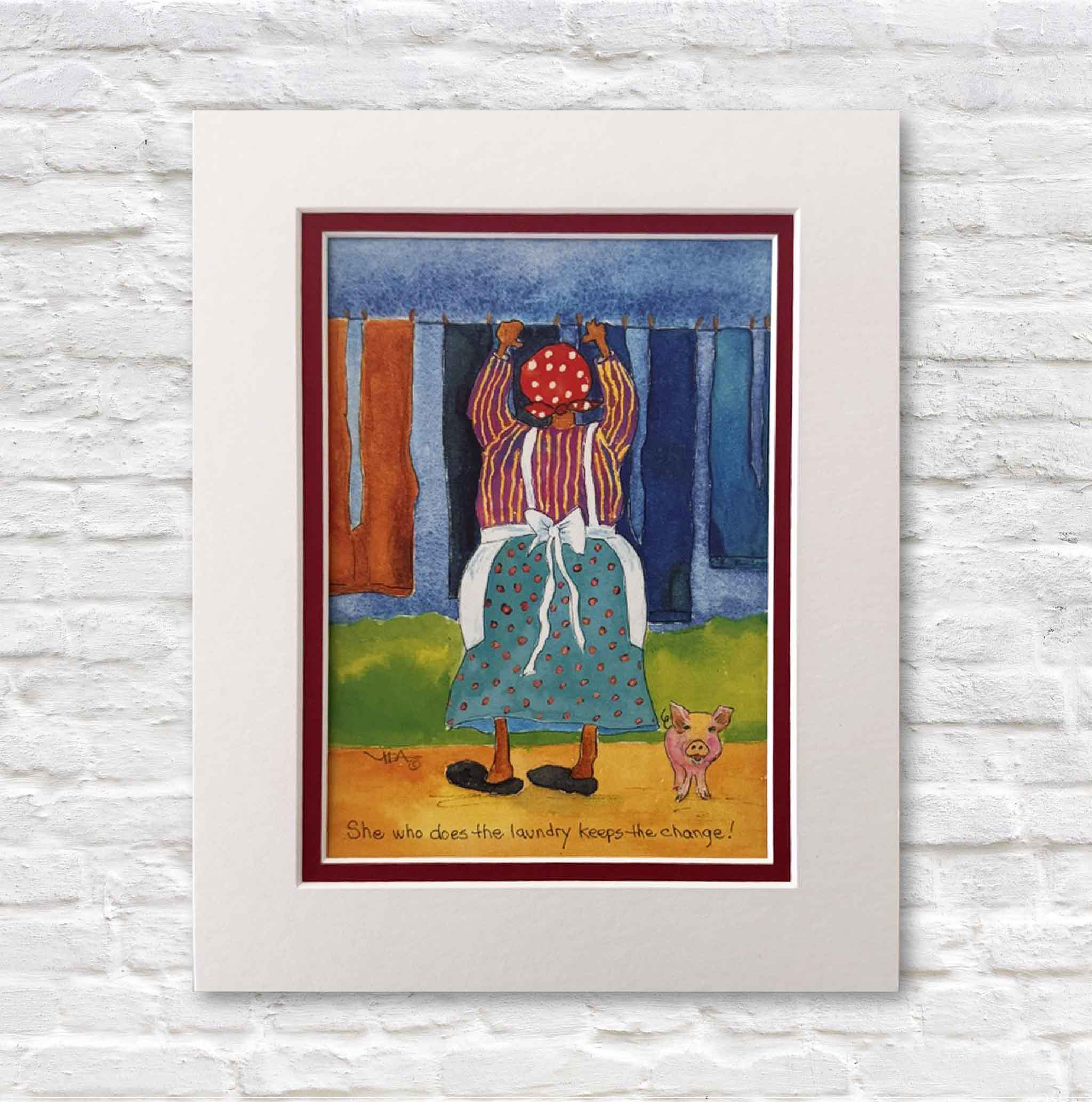 Matted artwork of a woman hanging laundry with a pig on a white brick wall.